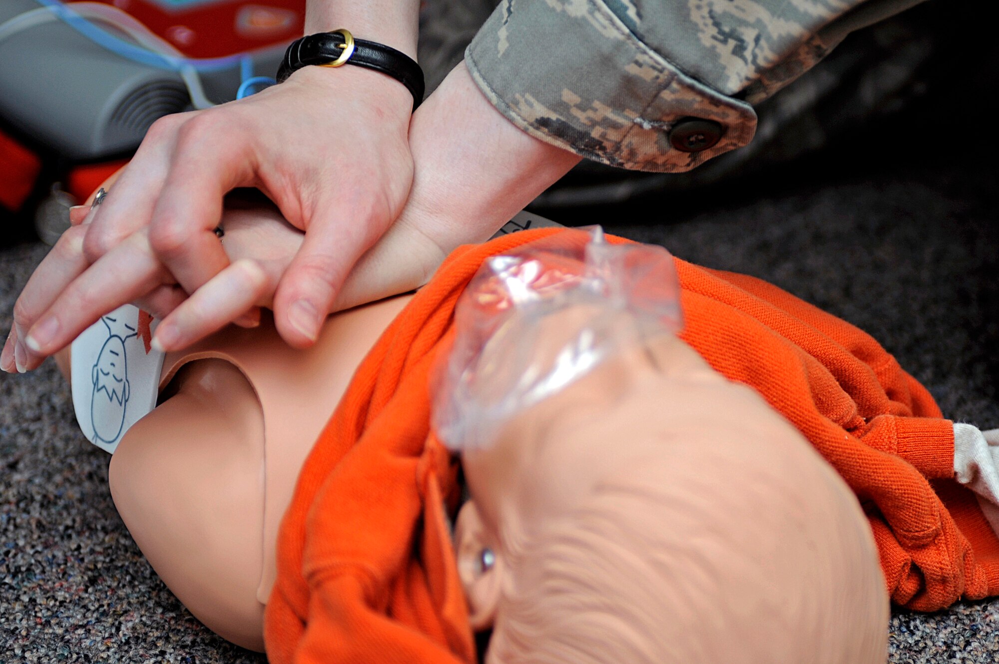 ELLSWORTH AIR FORCE BASE, S.D. - Tech. Sgt. Elizabeth Nagy, 28th Bomb Wing equal opportunity NCO in-charge, performs chest compressions on a child-sized dummy during a heart saver certification course, April 20. When performing cardio pulmonary resuscitation on a child, five sets of 30 chest compressions must be performed before contacting emergency responders. Depending on the size of the child, chest compressions may need to be performed using one hand. (U.S. Air Force photo/Airman 1st Class Matthew Flynn)