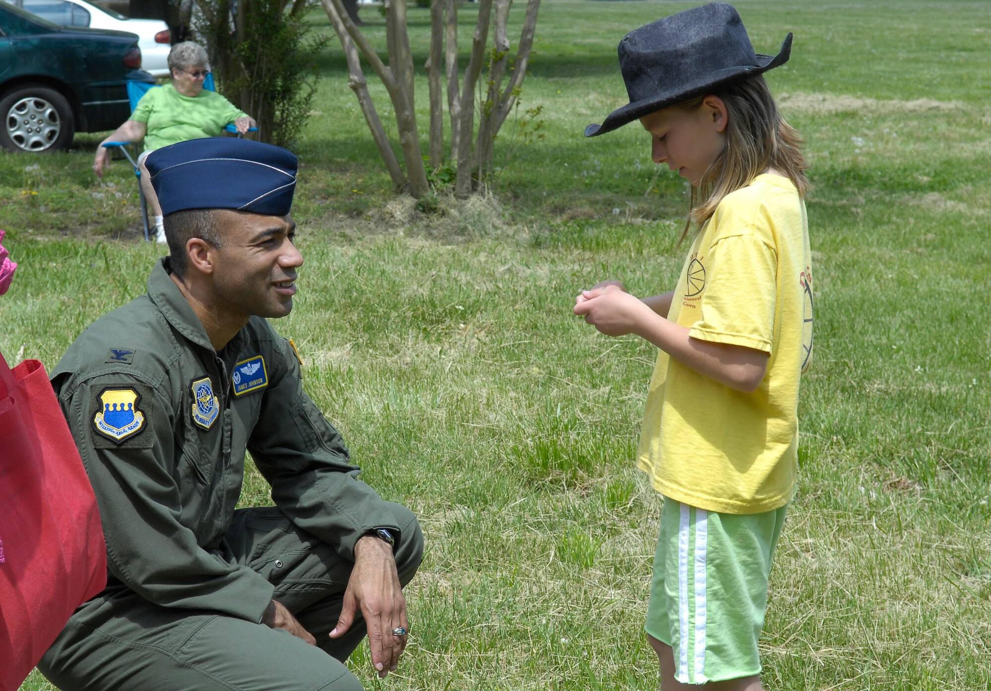 Col. James Johnson, 43rd Airlift Wing Commander, speaks with a child during an Earth Day celebration, April 17 in Erwin, N.C.. Members from the Pope Honor Guard and 43rd Security Forces Squadron working dogs performed demonstrations to commemorate the day. (U.S. Air Force Photo/Vicki Johnson) 