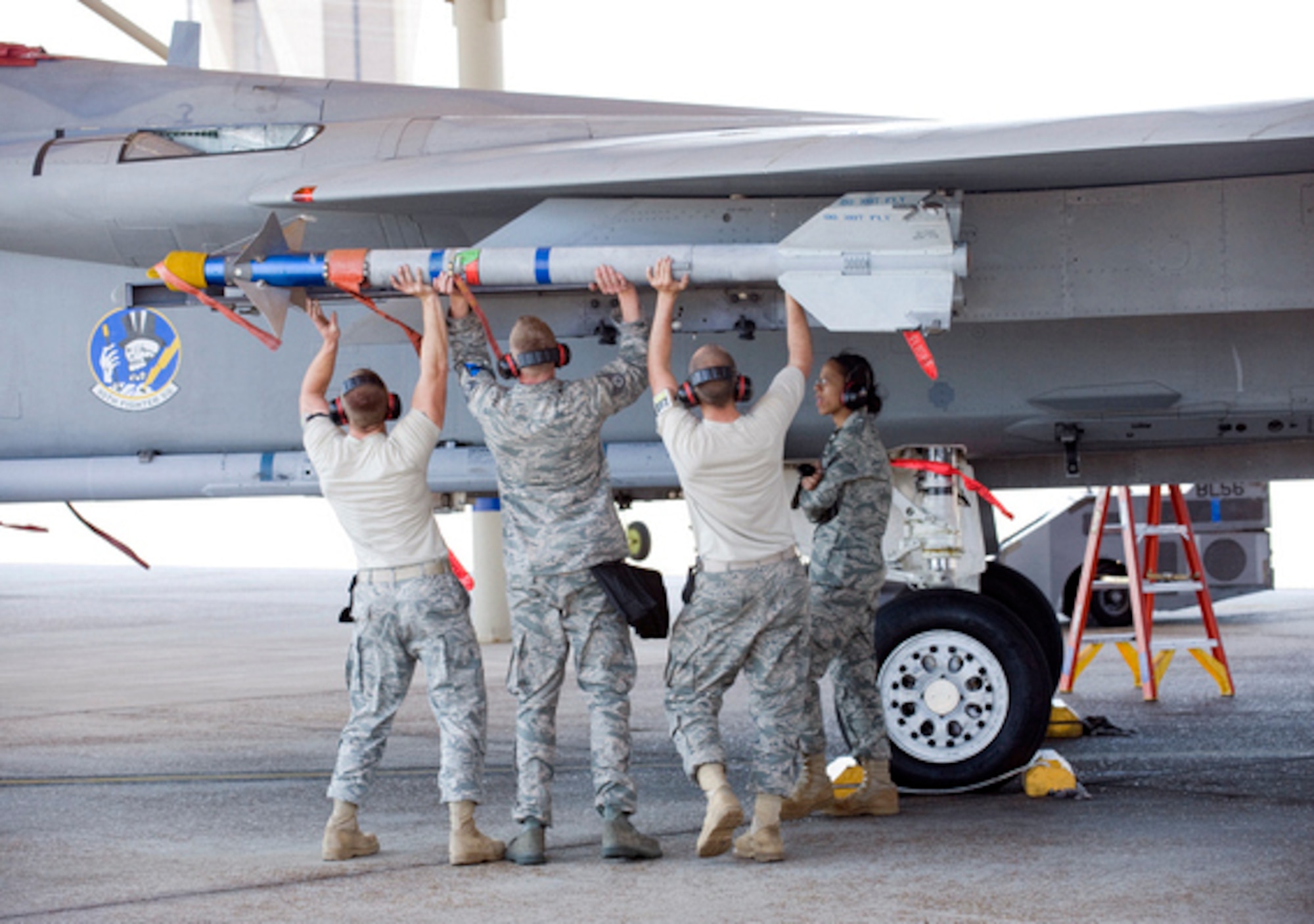 Members of the 95th Aircraft Maintenance Unit load weapons onto an F-15 eagle April 15 during the Load Crew Competition. (U.S. Air Force photo by Jonathan Gibson)