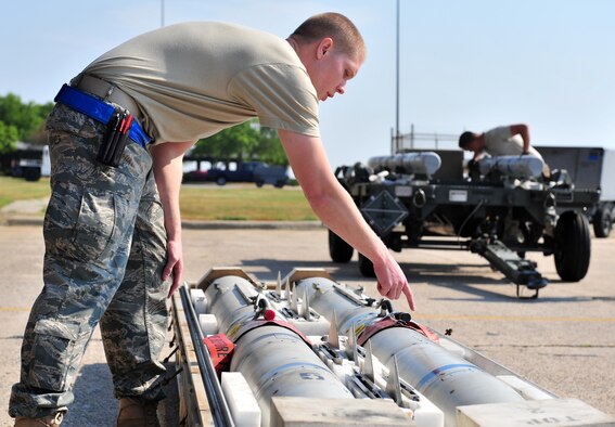 SHAW AIR FORCE BASE, S.C. -- Airman 1st Class Ryan Whitehead, 55th Aircraft Maintenance Unit, checks over missiles April 16, 2010. Wing weapons standardization held the first Weapons Load Crew of the Quarter competition for 2010. The 55th and 79th Aircraft Maintenance Units weapons load crews competed against each other in a race against time. Both load crews were tasked to load two air intercept missiles, or AIM - 120s, and two air-to-ground missiles, also known as AGM - 88s, within 45 minutes. (U.S. Air Force photo/Airman 1st Class Amber E. N. Jacobs)