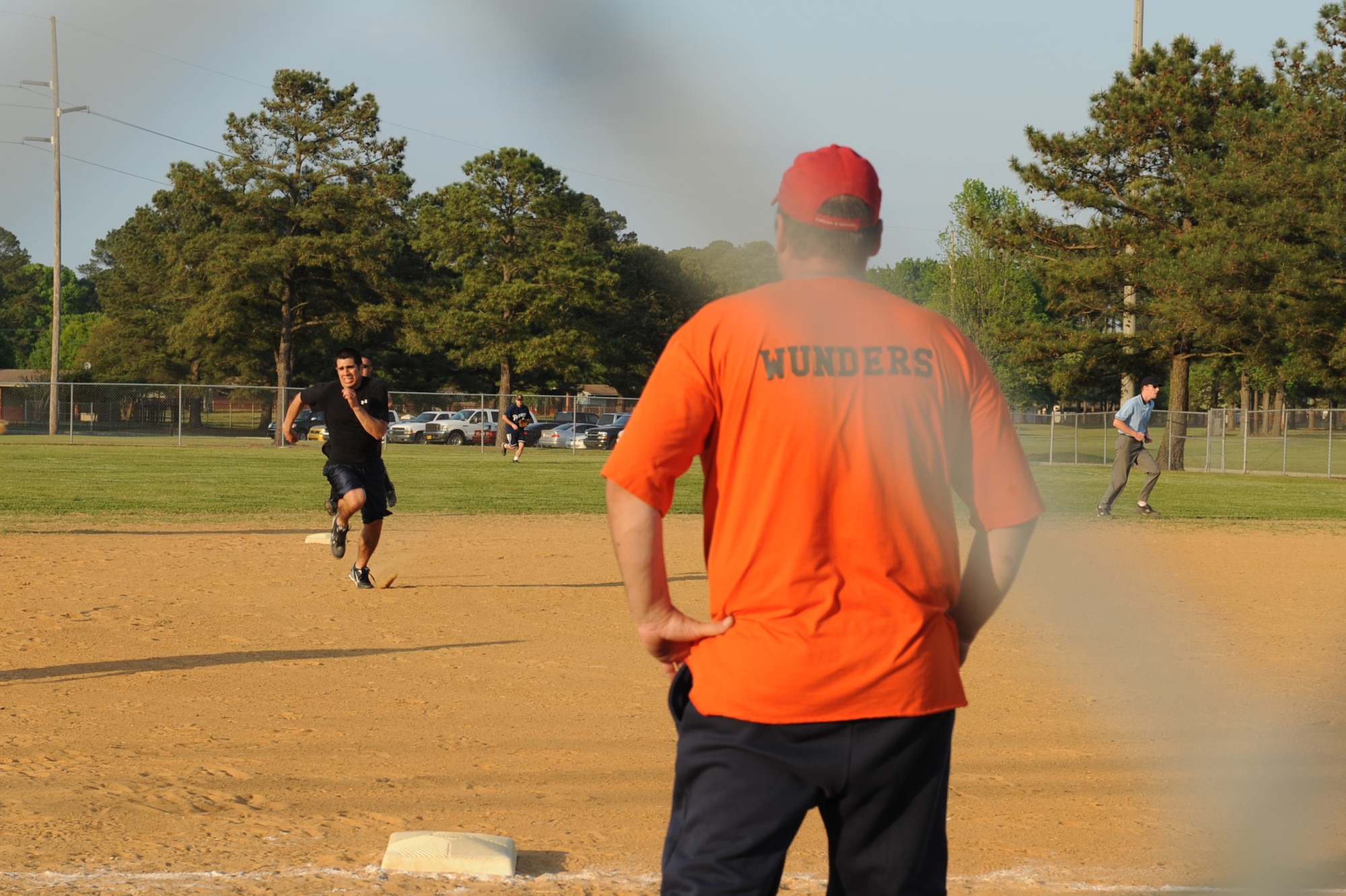 SEYMOUR JOHNSON AIR FORCE BASE, N.C. -- Jimi Wunders instructs Juan Barron as he runs to third base during an intramural softball game here April 13, 2010. Barron is an outfielder and Wunders is a pitcher and third base coach on the 4th Medical Group team. The third base coach acts as a second pair of eyes for base runners. Barron hails from Rock Fall, Ill., and Wunders hails from Middletown, N.Y. (U.S. Air Force photo/Senior Airman Whitney Lambert)