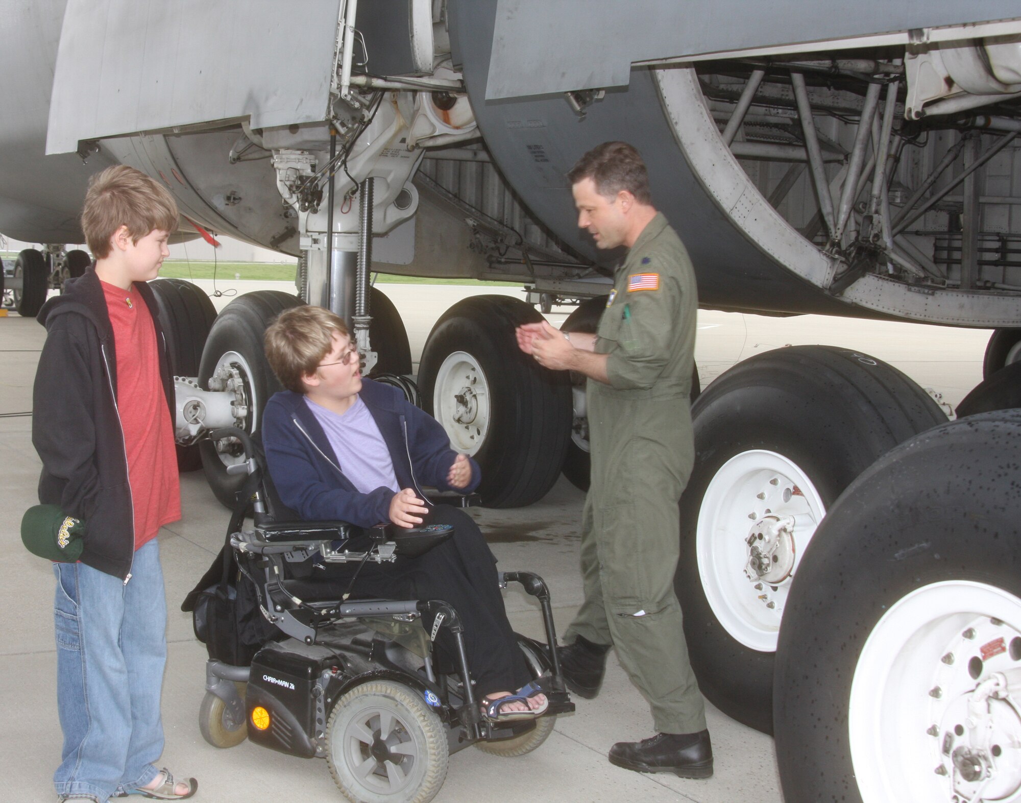 WRIGHT-PATTERSON AIR FORCE BASE, Ohio – Aviation buff Austin Whitmoyer, 13, and his brother, Tyler, 11, on the left, learn the logistics of the C-5 Galaxy from Lt. Col. Stephen Schnell, 89th Airlift Squadron, April 16.  The National Museum of the U.S. Air Force and Colonel Schnell, with assistance from A Special Wish Foundation, Inc., coordinated the visit for Austin and his family.  In addition to touring the C-5, Austin and his family visited the museum.  Austin was born with duchenne muscular dystrophy, a degenerative disease that affects all major muscle groups. (U. S. Air Force photo/Stacy Vaughn)