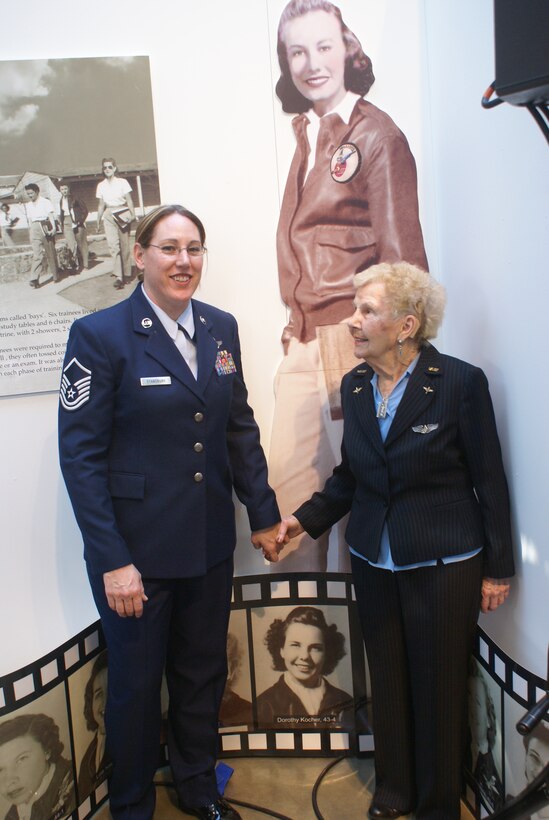 Master Sgt. Marti Stansbury, 326th Airlift Squadron loadmaster, and Dorothy Kocher-Olson, one of the Women Air Force Service Pilots, tour the WASP exhibit in Washington D.C., as part of two days of events, honoring all WASPs. Ms. Olson stands next to her picture, which she and Sergeant Stansbury found in a WASP display. The Congressional Gold Medal was also presented to the group during a ceremony attended by thousands. Sergeant Stansbury is one of five female aviators from the 512th Operations Group who volunteered to serve as a personal escort for a WASP. (U.S. Air Force photo)    