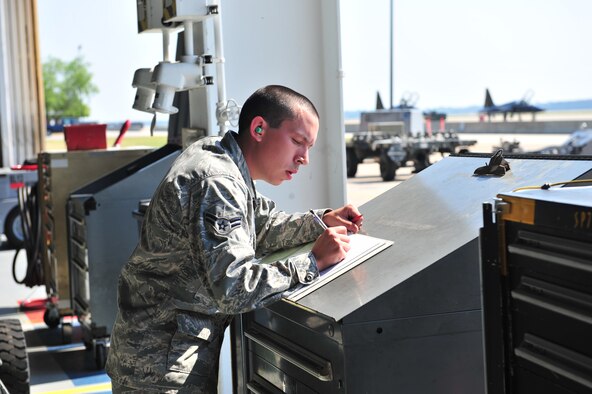 SHAW AIR FORCE BASE, S.C. -- Airman 1st Class Hunter Haley, 79th Aircraft Maintenance Unit, fills out paperwork April 16, 2010. Wing weapons standardization held the first Weapons Load Crew of the Quarter competition for 2010. The 55th and 79th Aircraft Maintenance Units weapons load crews competed against each other in a race against time. Both load crews were tasked to load two air intercept missiles, or AIM - 120s, and two air-to-ground missiles, also known as AGM - 88s, within 45 minutes. (U.S. Air Force photo/Airman 1st Class Amber E. N. Jacobs)