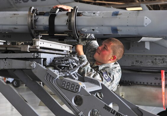 SHAW AIR FORCE BASE, S.C. -- Staff Sgt. James Seagle, 79th Aircraft Maintenance Unit, secures a missile on to the F-16 April 16, 2010. Wing weapons standardization held the first Weapons Load Crew of the Quarter competition for 2010. The 55th and 79th Aircraft Maintenance Units weapons load crews competed against each other in a race against time. Both load crews were tasked to load two air intercept missiles, or AIM - 120s, and two air-to-ground missiles, also known as AGM - 88s, within 45 minutes. (U.S. Air Force photo/Airman 1st Class Amber E. N. Jacobs)
