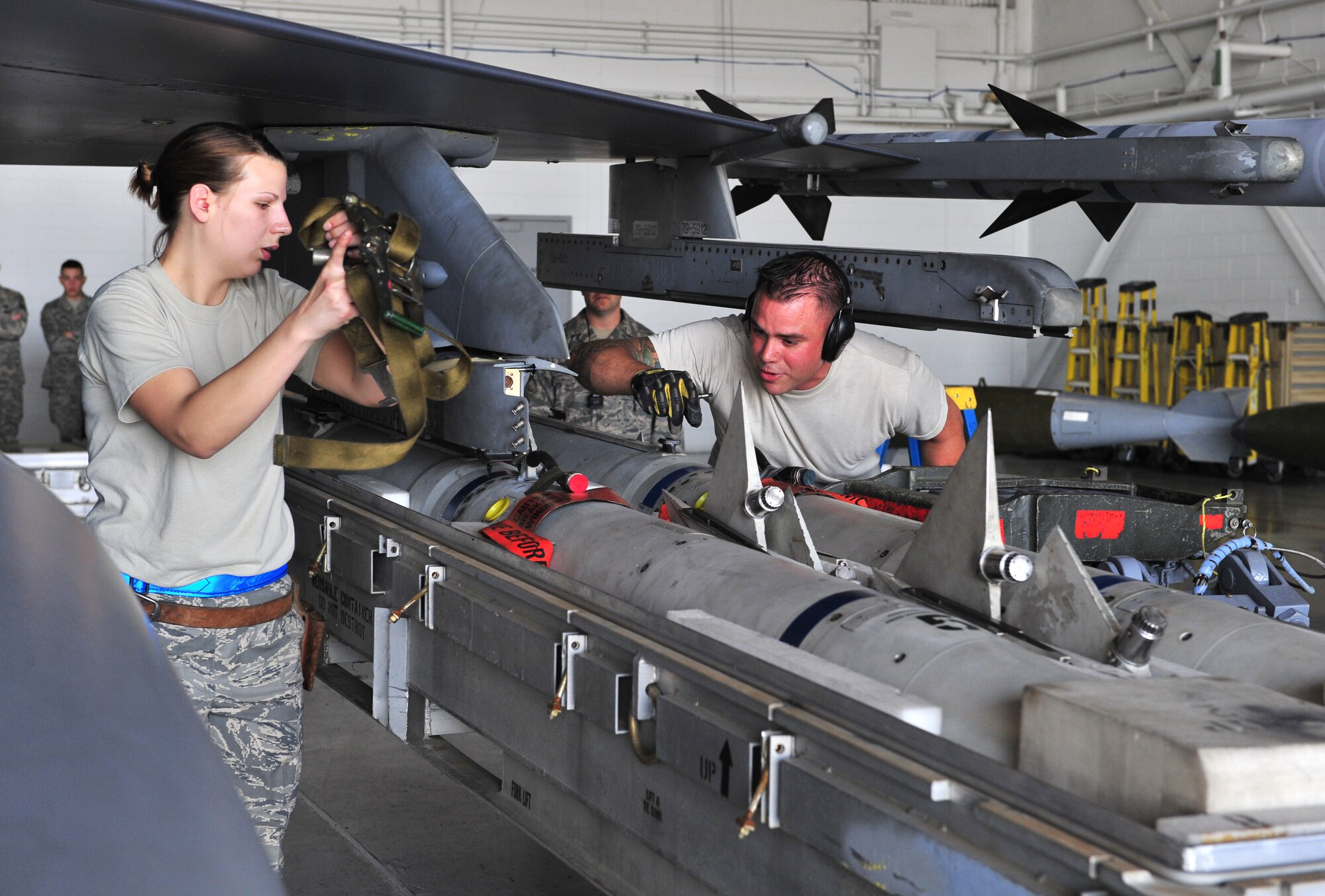 100416-F-8430J-129
SHAW AIR FORCE BASE, S.C. -- Airman 1st Class Nicole Nuemann (left) and Staff Sgt. Christopher Benton Jr., 55th Aircraft Maintenance Unit, secures a missile to the F-16 April 16, 2010. Wing weapons standardization held the first Weapons Load Crew of the Quarter Competition for 2010. The 55th and 79th Aircraft Maintenance Units Weapons load crews competed against each other in a race against time. Both load crews were tasked to load two air intercept missiles (AIM - 120) and two air-to-ground missiles (AGM - 88) within 45 minutes.   (U.S. Air Force photo/Airman 1st Class Amber E. N. Jacobs)