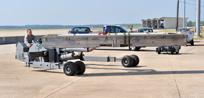 SHAW AIR FORCE BASE, S.C. -- Airman 1st Class Hunter Haley, 79th Aircraft Maintenance Unit, drives a bomb lift truck carrying missiles April 16, 2010. Wing weapons standardization held the first Weapons Load Crew of the Quarter competition for 2010. The 55th and 79th Aircraft Maintenance Units weapons load crews competed against each other in a race against time. Both load crews were tasked to load two air intercept missiles, or AIM - 120s, and two air-to-ground missiles, also known as AGM - 88s, within 45 minutes. (U.S. Air Force photo/Airman 1st Class Amber E. N. Jacobs)