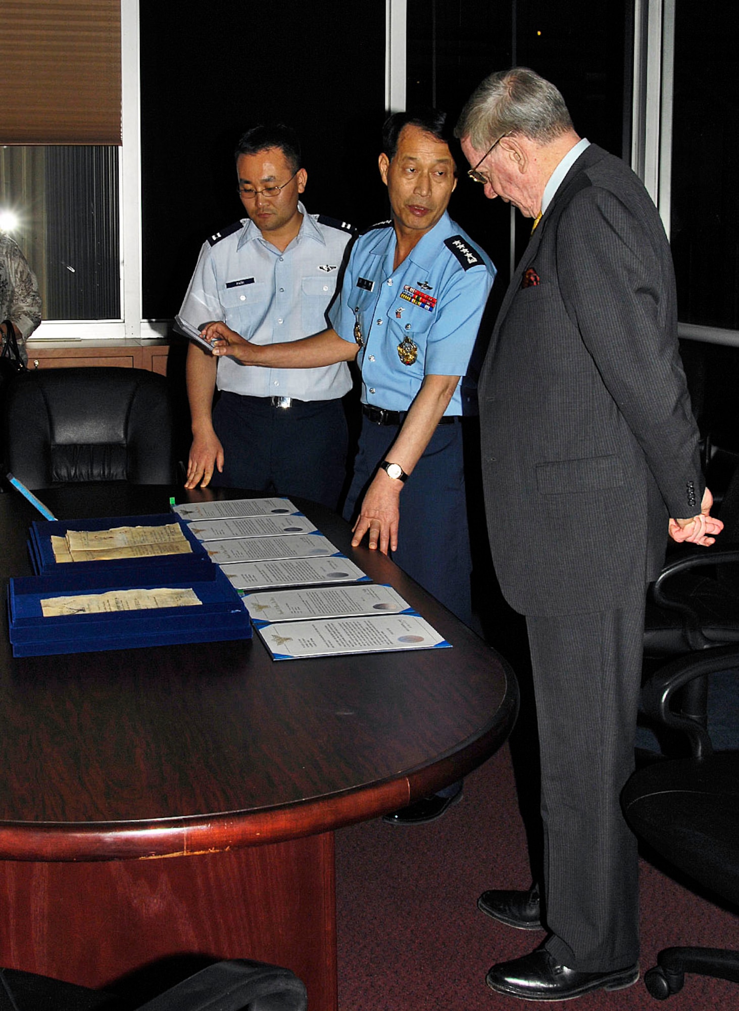 DAYTON, Ohio -- General Lee Kae Hoon (center), Republic of Korea Air Force Chief of Staff, explains the significance of items he has donated to Maj. Gen. (Ret.) Charles D. Metcalf, director of the National Museum of the United States Air Force, during a visit on April 19, 2010. The items will be used in the museum's Korean War exhibit, which is being completely redesigned to commemorate the 60th anniversary of the beginning of the Korean War. (U.S. Air Force photo by Mike Libecap)