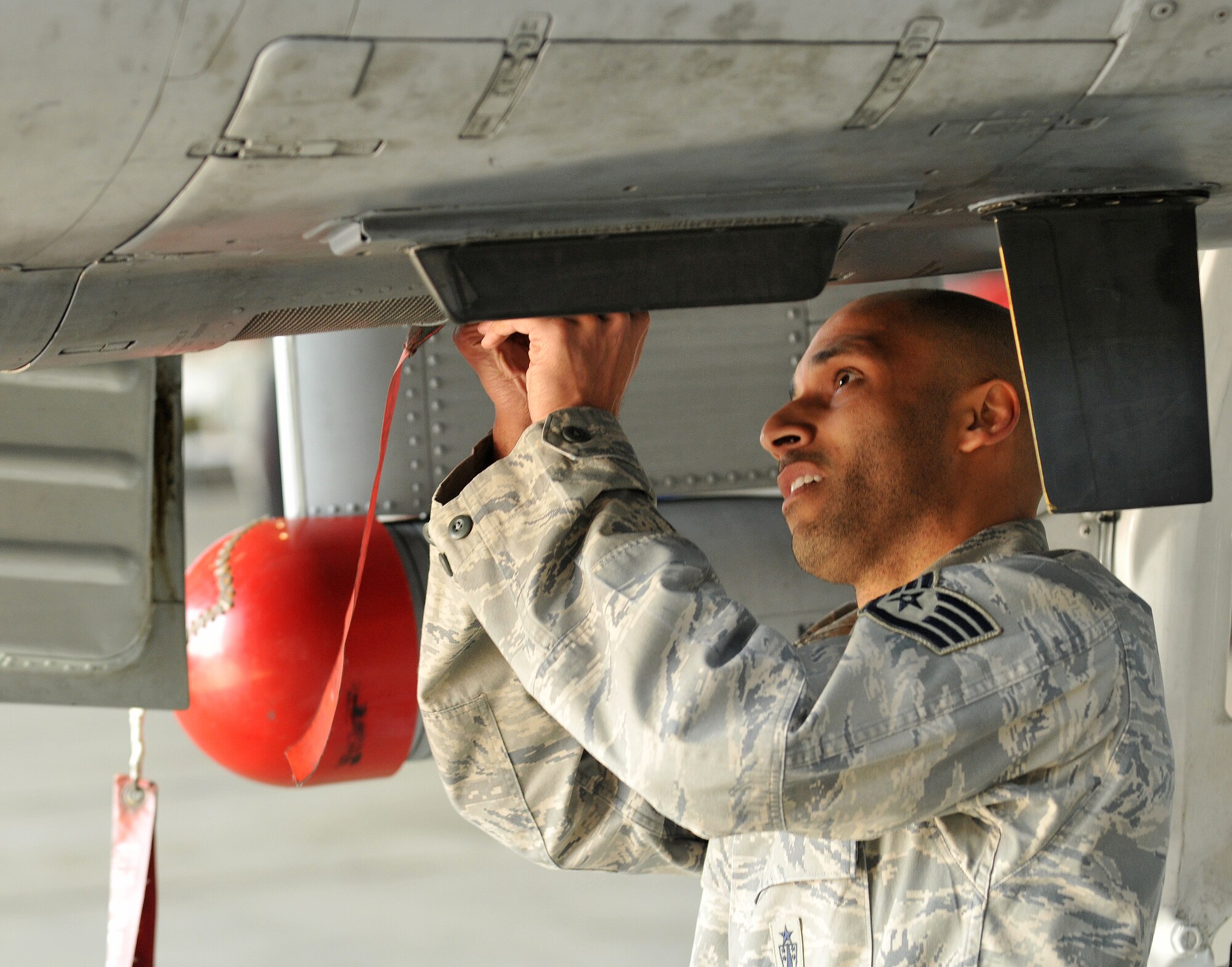 SPANGDAHLEM AIR BASE, Germany -- Staff Sgt. Rafael Gabriel, 52nd Aircraft Maintenance Squadron weapons load team chief, ensures an A-10 Thunderbolt’s gun panel is closed during aircraft preparation at the 52nd Fighter Wing Load Crew of the Quarter competition April 16. The competition pitted three of the wing’s best load crews against each other to crown the best for the first quarter of 2010. The competition consisted of a dress and appearance evaluation and composite tool-box inspection. The teams were challenged to have the fastest times while completing a munitions load with no safety write-ups. (U.S. Air Force photo/Airman 1st Class Nick Wilson)