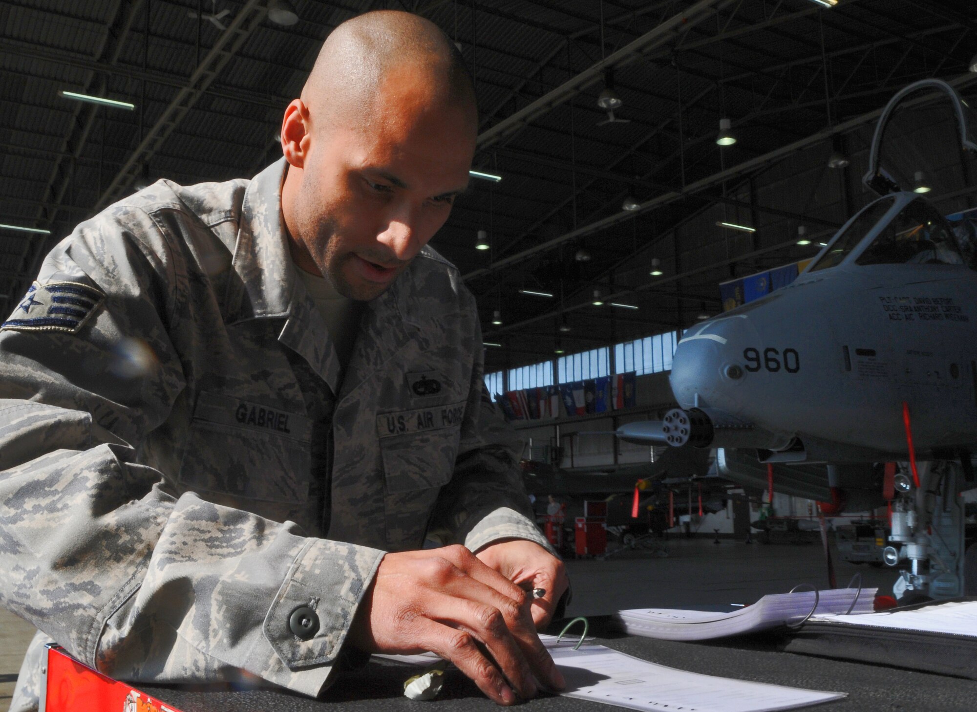 SPANGDAHLEM AIR BASE, Germany -- Staff Sgt. Rafael Gabriel, 52nd Aircraft Maintenance Squadron weapons load crew team chief, performs final steps from a checklist after loading munitions onto an A-10 Thunderbolt during the 52nd Fighter Wing Load Crew of the Quarter competition April 16. The competition pitted three of the wing’s best load crews against each other to crown the best for the first quarter of 2010. The competition consisted of a dress and appearance evaluation and composite tool-box inspection. The teams were challenged to have the fastest times while completing a munitions load with no safety write-ups. (U.S. Air Force photo/Airman 1st Class Nick Wilson)