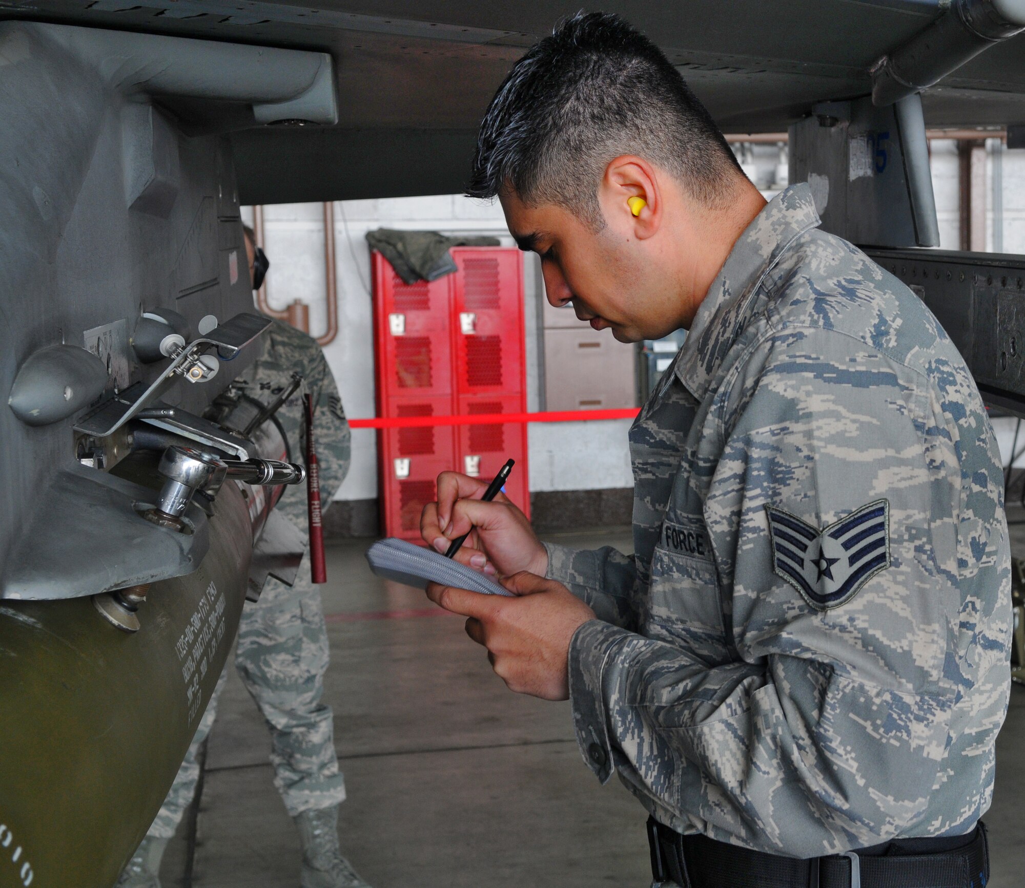 SPANGDAHLEM AIR BASE, Germany -- Staff Sgt. Richard Bates, 52nd Maintenance Operation Squadron weapons load crew team chief, reviews a checklist to ensure no steps were missed after locking his munition onto an F-16 Fighting Falcon during the 52nd Fighter Wing Load Crew of the Quarter competition April 16. The competition challenged Airmen from the 52nd Aircraft Maintenance Squadron to safely and efficiently load munitions onto their aircraft. Sergeant Bates was the lead member of the three-man team that won the competition. (U.S. Air Force photo/Airman 1st Class Nick Wilson)