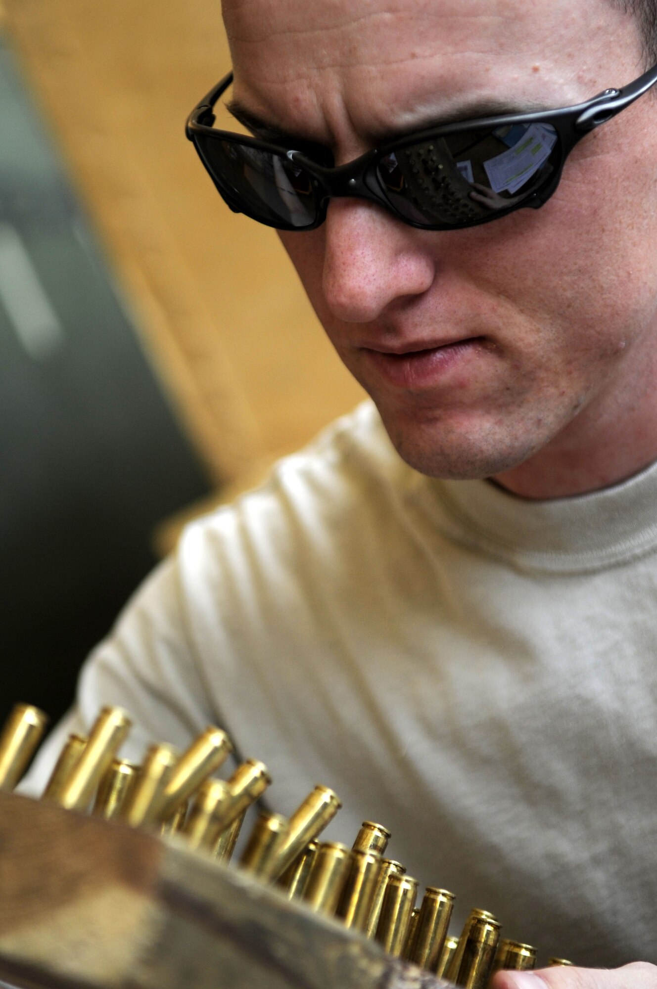 Senior Airman Jacob Spencer, a Combat Arms Training and Maintenance journeyman assigned to the 451st Expeditionary Security Forces Squadron, confirms the lot number on ammunition turned in by a member of the 451st EAMXS during a visit to the unit, April 16.  (U.S. Air Force photo by Senior Airman Nancy Hooks/Released)
