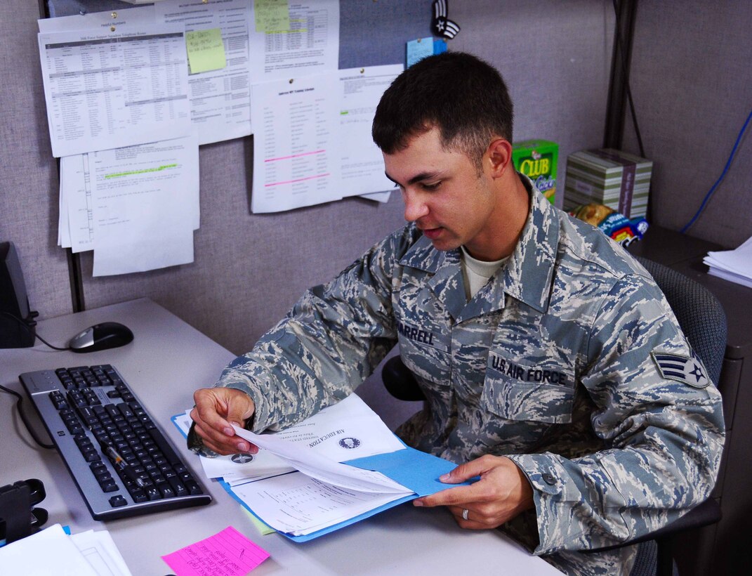 ANDERSEN AIR FORCE BASE, Guam - Senior Airman Jeffrey Harrell, 36th Force Support Squadron customer service representative, organizes his workload here April 20. Airman Harrell was recognized as a 'Top Performer' by Master Sgt. Jose Magana, 36th FSS first sergeant. (U.S. Air Force photo by Airman 1st Class Jeffrey Schultze)  

