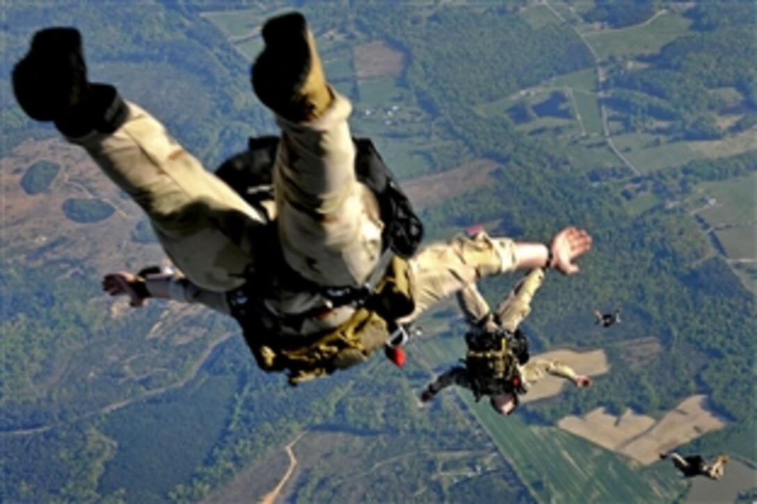 After jumping from the ramp of a C-17 Globemaster III, U.S. Navy SEALs free fall over Fort Picket Maneuver Training Center, Va., April 15, 2010. The jump was part of a joint training exercise with 517th Airlift Squadron members from Elmendorf Air Force Base, Alaska.