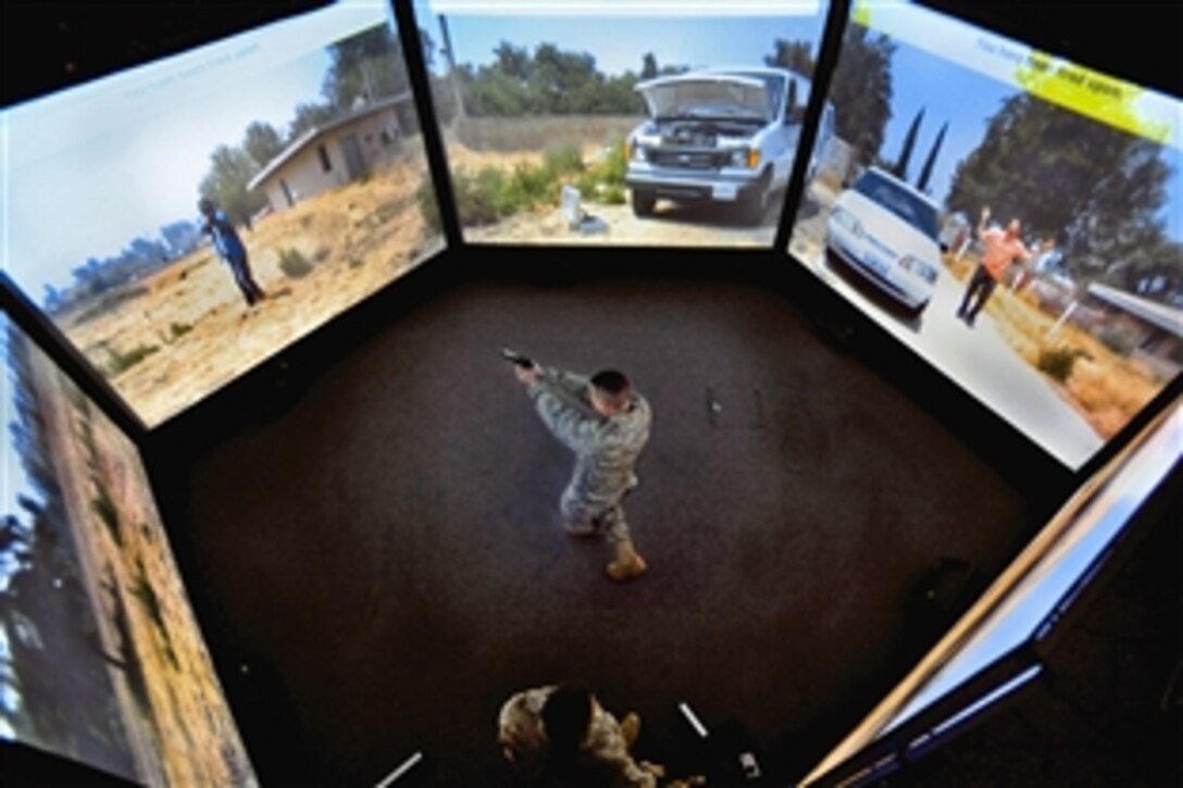 U.S. Air Force Capt. Kevin Snow exchanges gunfire with an "attacker" during a training scenario in the 621st Contingency Response Wing's new virtual firearms training simulator on Joint Base McGuire-Dix-Lakehurst, N.J., April 15, 2010. The Air Force uses the simulator with the 300-degree view to train airmen to anticipate and react appropriately to threats from any direction. Snow is the 818th Global Mobility Squadron's assistant operations officer.