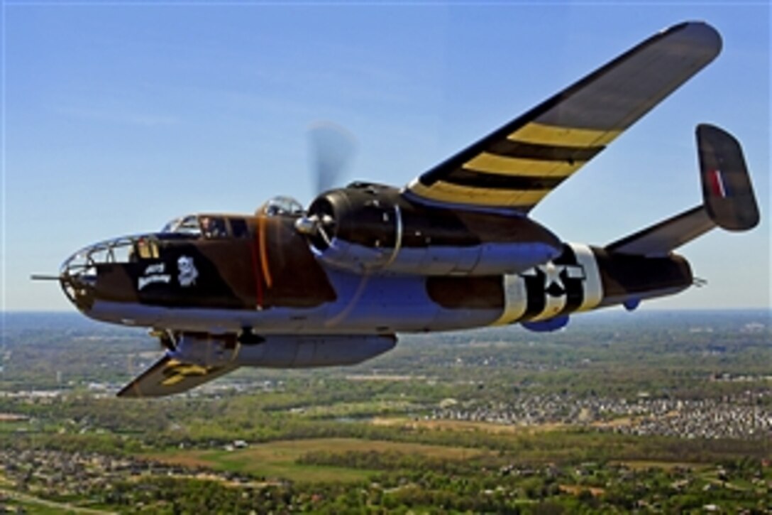 A vintage B-25 Mitchell bomber flies near the National Museum of the U.S. Air Force on Wright-Patterson Air Force Base, Ohio, during a memorial flight honoring the Doolittle Tokyo Raiders, April 18, 2010. The 68th Doolittle Raiders reunion commemorates the anniversary of the Doolittle Tokyo Raid. U.S. Army Air Forces Lt. Col. Jimmy Doolittle's squad of 16 B-25 Mitchell aircraft bombed Japanese targets, April 18, 1942, in response to the attack on Pearl Harbor.
