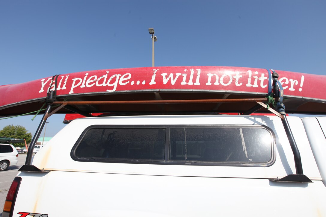 Elmer Eddy’s canoe advertises a “No Littering” campaign aboard Marine Corps Base Camp Lejeune, April 22.  Volunteers from North Carolina and service members rode in kayaks and canoes to pick up trash, tires and old toys along the coastline of New River in celebration of Earth Day.