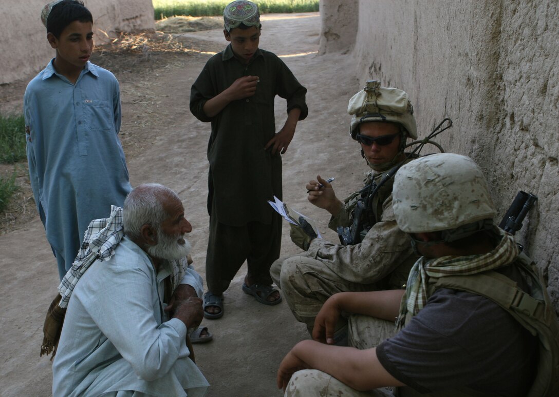 Corporal Timothy Stark, a squad leader with Weapon’s Company, 1st Battalion, 6th Marine Regiment meets with a farmer and his family in order to verify whether or not he’s successfully changed his crop from poppy, Marjah, Afghanistan, April 23. While out on patrol Marine and Afghan forces with 1/6 met with local farmers and landowners who are participating in the Marjah Accelerated Agricultural Transition program.