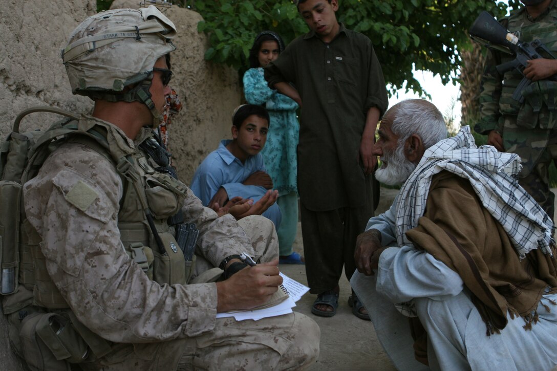 Corporal Timothy Stark, a squad leader with Weapon’s Company, 1st Battalion, 6th Marine Regiment meets with a farmer and his family in order to verify whether or not he’s successfully changed his crop from poppy, Marjah, Afghanistan, April 23. While out on patrol Marine and Afghan forces with 1/6 met with local farmers and landowners who are participating in the Marjah Accelerated Agricultural Transition program.