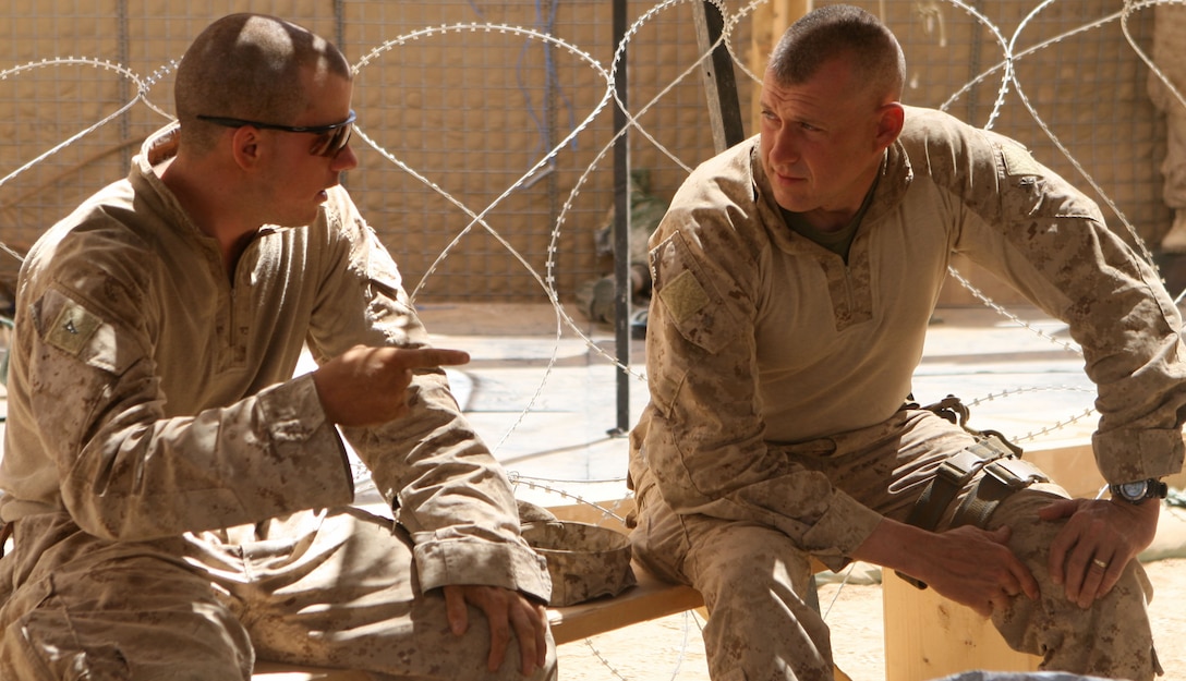Major Billy Ray Moore (right), the 3rd Battalion, 6th Marine Regiment, executive officer, speaks with Lance Cpl. Robert Tyler Powell, a TOW gunner from India Company, during the XO's Road Show in Marjah, Helmand province, Afghanistan, April 23, 2010. The XO's Road Show is a mobile exhibition which provides special services, assets and a resupply to each of the battalion's line companies. (USMC photo by Lance Cpl. Tommy Bellegarde)
