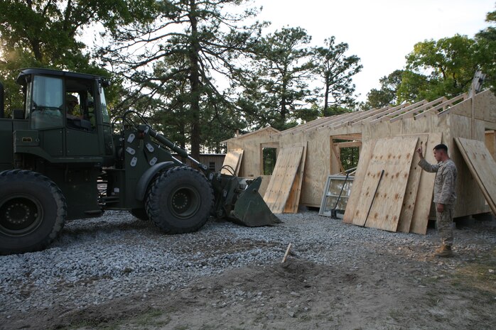 Marines with Combat Logistics Battalion 2, 2nd Marine Logistics Group, flatten the foundation to begin construction of a Southwest Asia hut during the battalion’s field exercise at Fort Bragg, N.C. April 23, 2010.  The battalion conducted the exercise to simulate combat logistics convoy operations, general engineering and command and control operations in preparation for their future deployment to Afghanistan.  (U.S. Marine Corps photo by Gunnery Sgt. Katesha Washington)