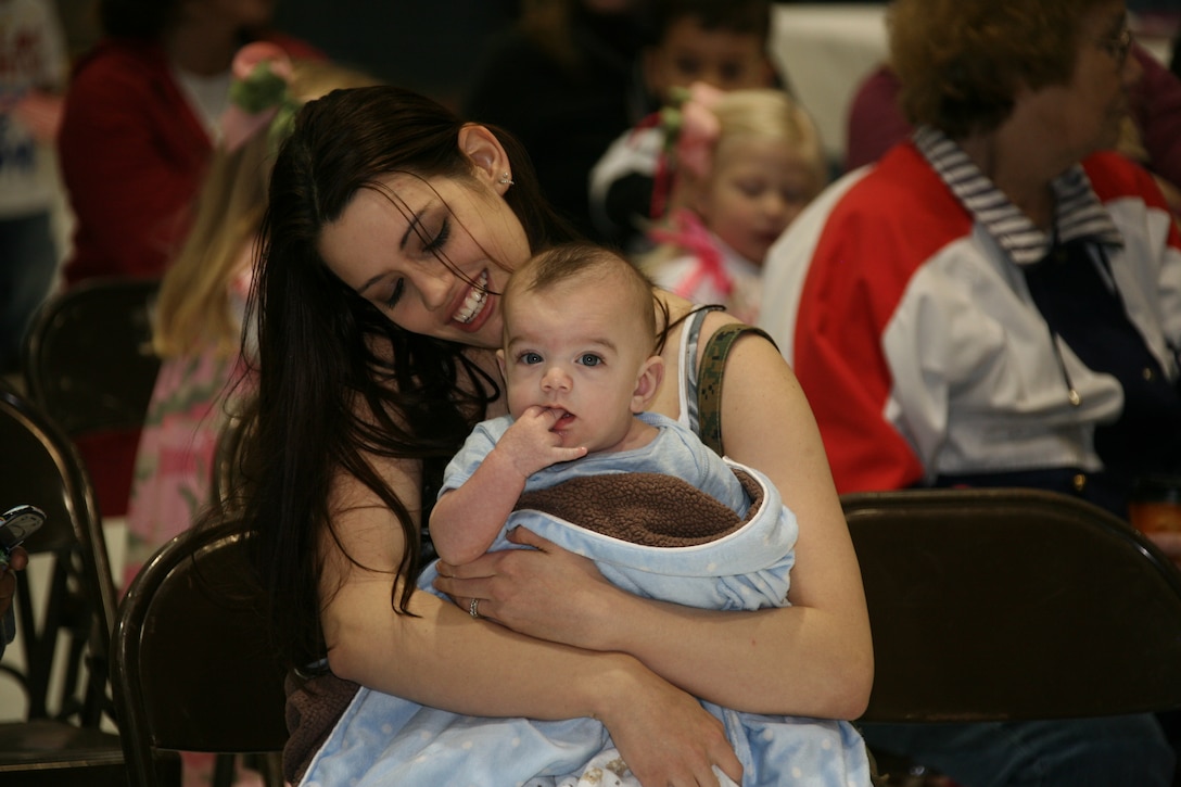 Christine R. Masker and her 4-month old son, Hunter, both wait for dad, Lance Cpl. Andrew T. Masker, an airframe mechanic with Marine Tactical Electronic Warfare Squadron 1. Masker and other Marines from VMAQ-1 returned to the air station April 21, after a six-moth deployment to Afghanistan.