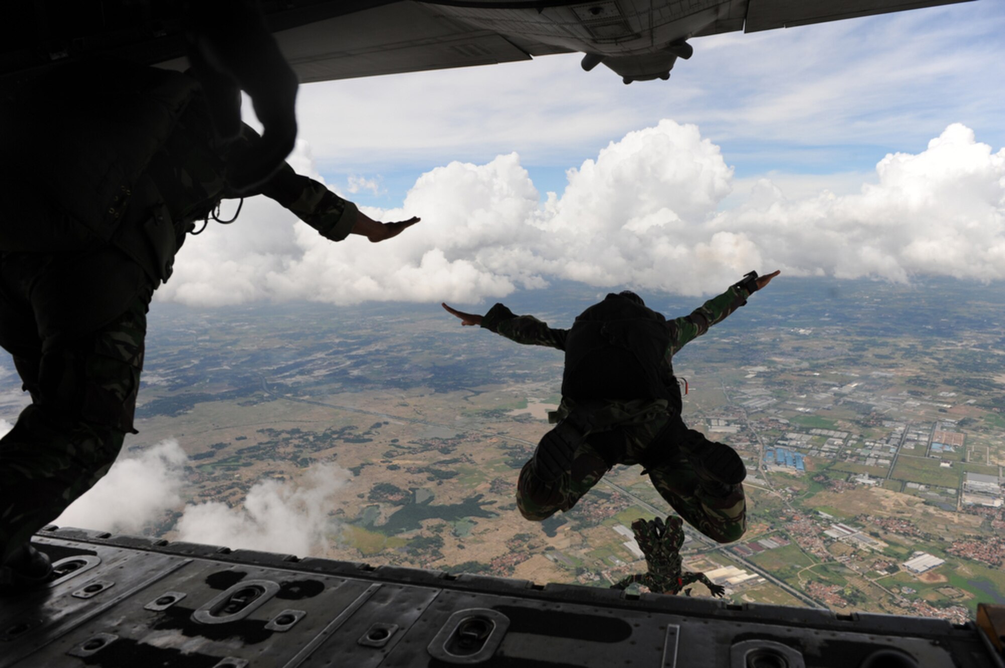 Indonesian jumpmasters leap out of a C-130 Hercules from the 36th Airlift Squadron out of Yokota Air Base, Japan, while over the Gorda drop zone in Indonesia on April 22, 2010.  U.S. and Indonesian airmen are participating in Cope West 10, a Pacific Air Forces-sponsored bilateral tactical airlift exercise involving the U.S. and Indonesian air forces. The exercise is designed to advance interoperability between the two services, and promote cooperation and unity of purpose.  (U.S. Air Force photo/Tech. Sgt. Cohen A. Young)