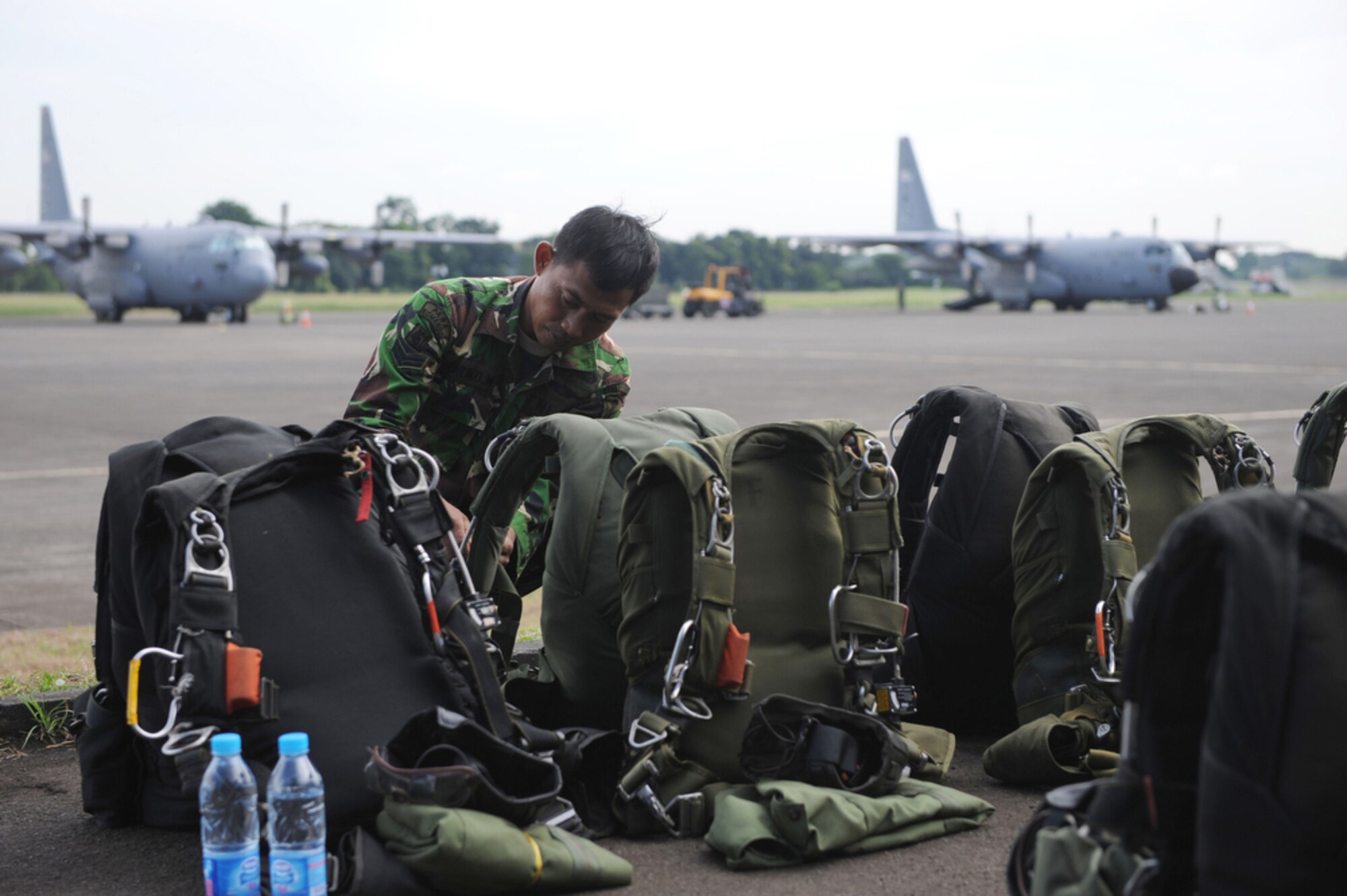 An Indonesian jumpmaster prepares his gear at Halim Air Base, Indonesia, before boarding a C-130 Hercules from the 36th Airlift Squadron out of Yokota Air Base, Japan, on April 22, 2010.  U.S. and Indonesian airmen are participating in Cope West 10, a Pacific Air Forces-sponsored bilateral tactical airlift exercise involving the U.S. and Indonesian air forces. The exercise is designed to advance interoperability between the two services, and promote cooperation and unity of purpose.  (U.S. Air Force photo/Tech. Sgt. Cohen A. Young)