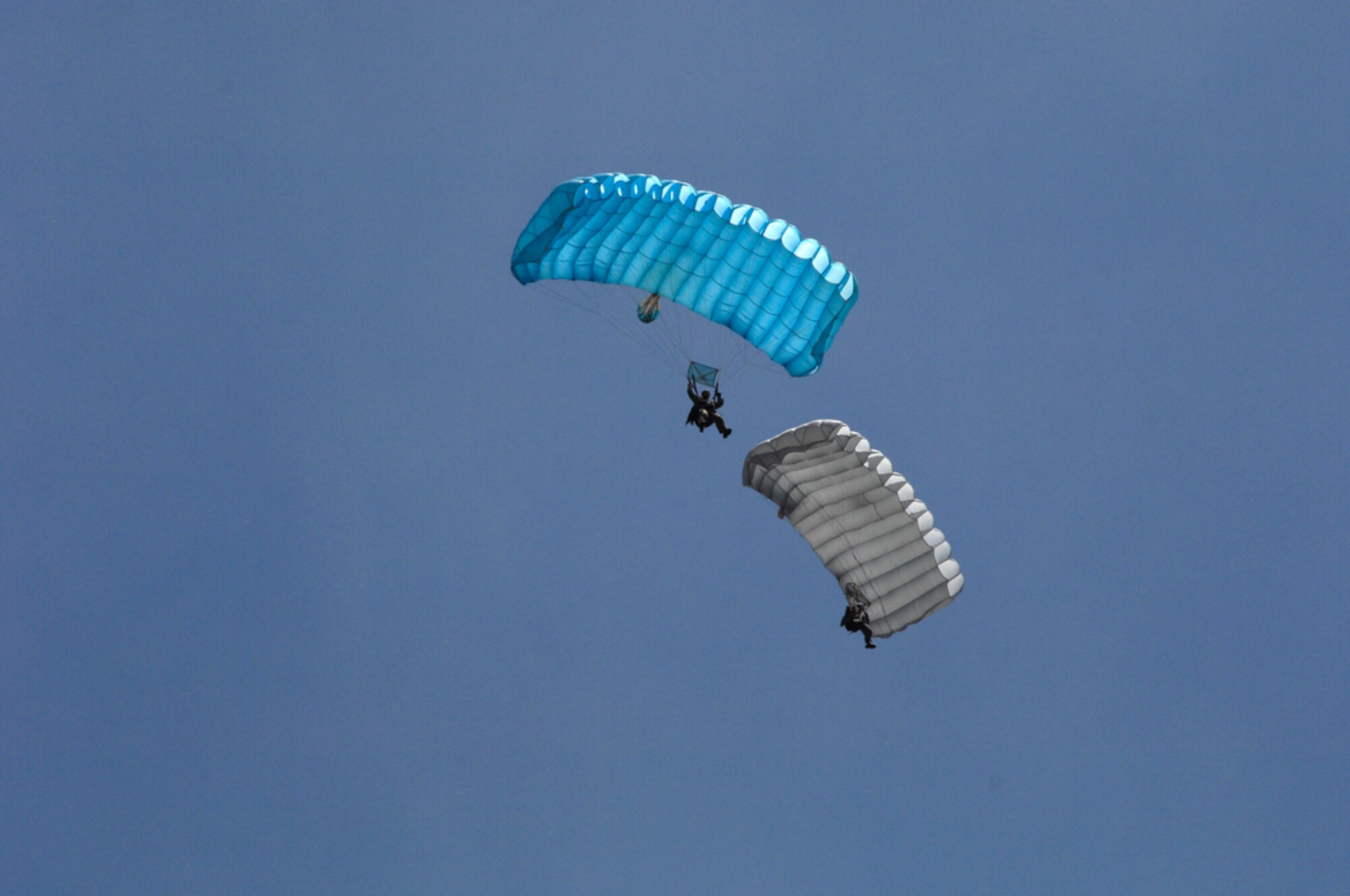 Two Indonesian soldiers jump from a U.S. Air Force C-130 Hercules assigned to the 36th Airlift Squadron at Yokota Air Base, Japan, during exercise Cope West 10 in Indonesia, April 21, 2010. Cope West is a Pacific Air Forces-sponsored bilateral tactical airlift exercise involving U.S. and Indonesian air forces. The exercise is designed to advance interoperability between U.S. and Indonesian air forces, and promote cooperation and unity of purpose.  (U.S.  Air Force photo/Tech Sgt. Cohen A. Young)