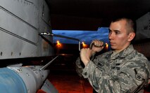 Airman Jon Casebolt, a weapons load crewmember with the 8th Aircraft Maintenance Squadron's 80th Aircraft Maintenance Unit, tightens a panel after installing an inert Joint Direct Attack Munition GBU-38s onto an F-16 Fighting Falcon during Red Flag-Alaska April 19 at Eielson Air Force Base, Alaska. Airman Casebolt is deployed from the 8th Fighter Wing, Kunsan Air Base, Republic of Korea. Red Flag-Alaska is a Pacific Air Forces-directed field training exercise for U.S. and coalition forces under simulated combat conditions. (U.S. Air Force photo/Capt. Shannon Collins) 