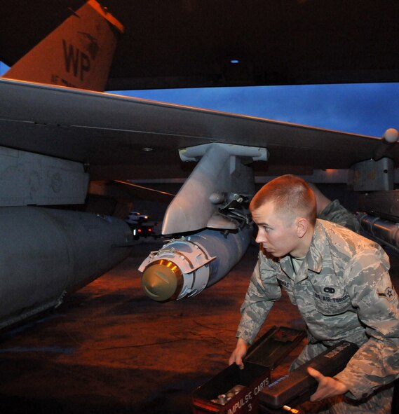 Airman Jon Casebolt, a weapons load crewmember, loads chaffs and flares onto an F-16 Fighting Falcon during Red Flag-Alaska April 19 at Eielson Air Force Base, Alaska. Airman Casebolt is deployed from the 8th Fighter Wing, Kunsan Air Base, Republic of Korea, and is assigned to the 8th Aircraft Maintenance Squadron's 80th Aircraft Maintenance Unit Juvats. Red Flag-Alaska is a Pacific Air Forces-directed field training exercise for U.S. and coalition forces under simulated combat conditions. (U.S. Air Force photo/Capt. Shannon Collins) 