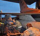Airman Jon Casebolt, weapons load crewmember, and Staff Sgt. Adam Hatch, weapons load crewchief, work with Senior Airman Troy Bledsoe, weapons load crewmember and jammer operator, to line up an inert Joint Direct Attack Munition GBU-38 before securing it to an F-16 Fighting Falcon during Red Flag-Alaska April 19 at Eielson Air Force Base, Alaska. All of the Airmen are deployed from the 8th Fighter Wing, Kunsan Air Base, Republic of Korea, and assigned to the 8th Aircraft Maintenance Squadron's 80th Aircraft Maintenance Unit Juvats. Red Flag-Alaska is a Pacific Air Forces-directed field training exercise for U.S. and coalition forces under simulated combat conditions. (U.S. Air Force photo/Capt. Shannon Collins) 