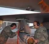 Airman Jon Casebolt, weapons load crewmember, and Staff Sgt. Adam Hatch, weapons load crewchief, secure an inert Joint Direct Attack Munition GBU-38 to an F-16 Fighting Falcon during Red Flag-Alaska April 19 at Eielson Air Force Base, Alaska. Both Airmen are deployed from the 8th Fighter Wing, Kunsan Air Base, Republic of Korea, and assigned to the 8th Aircraft Maintenance Squadron's 80th Aircraft Maintenance Unit Juvats. Red Flag-Alaska is a Pacific Air Forces-directed field training exercise for U.S. and coalition forces under simulated combat conditions. (U.S. Air Force photo/Capt. Shannon Collins) 