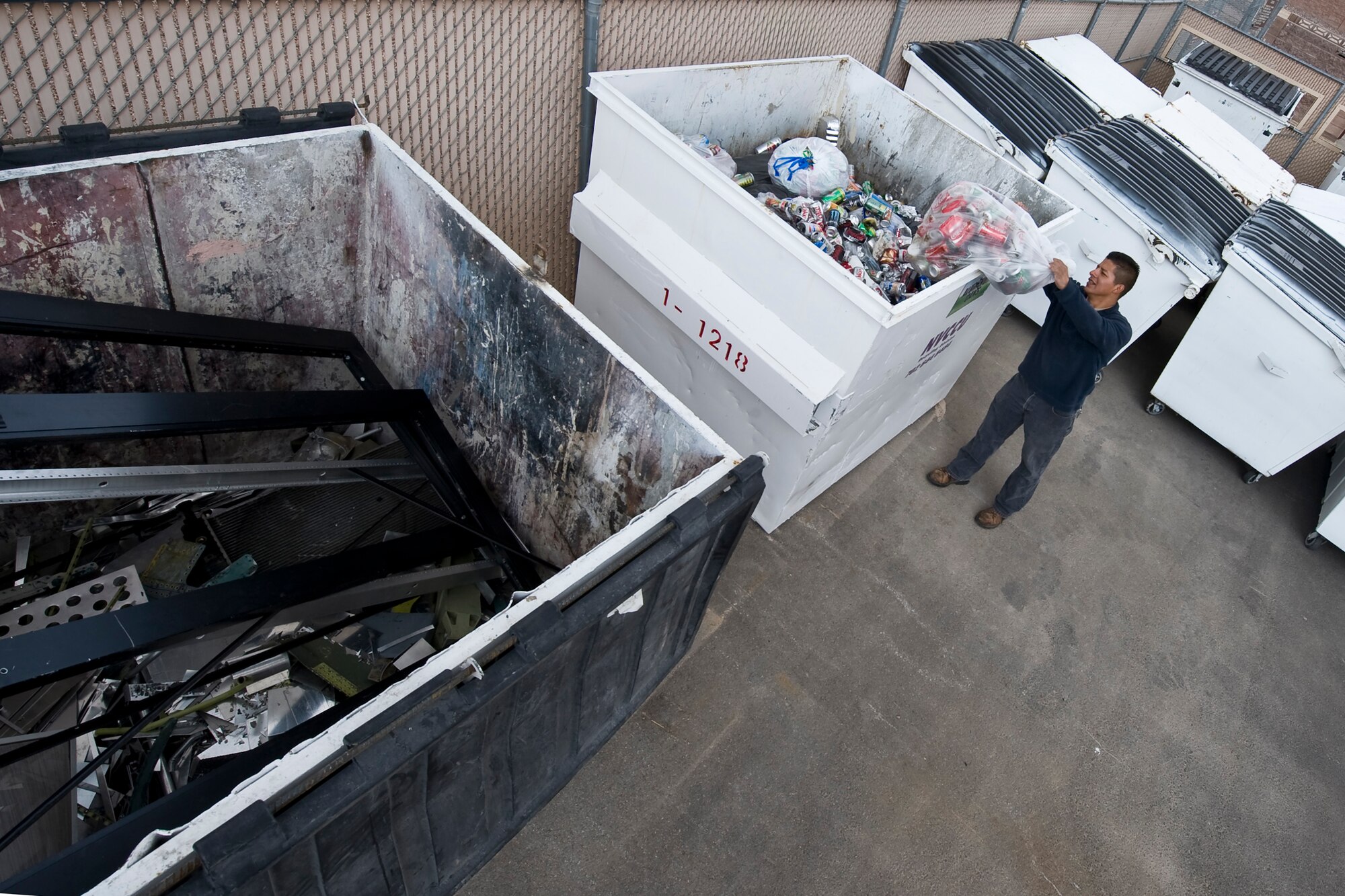 NELLIS AIR FORCE BASE, Nev. -- Juanpedro Monroy, 99th Civil Engineer Squadron, Recycling Operations Manager disposes aluminum cans at the base's recycling center April 22, 2010.  Nellis recycles more than 1000 pounds of aluminum each month as part of environmental conservation. (U.S. Air Force photo by Lawrence Crespo)
