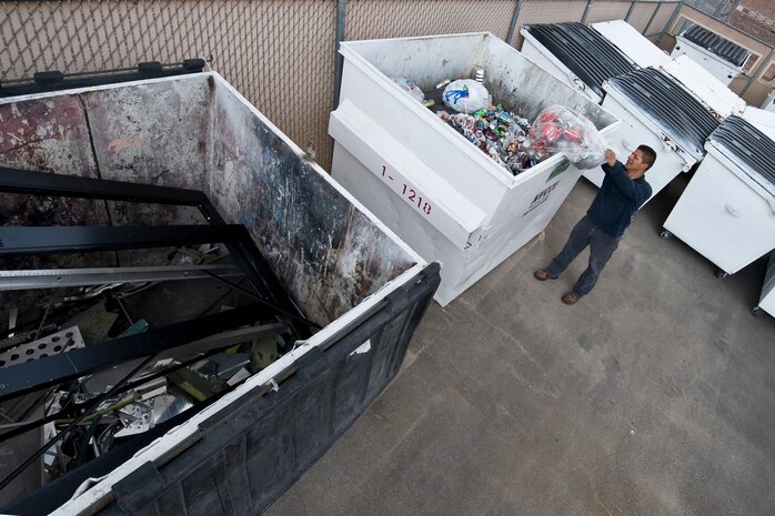 NELLIS AIR FORCE BASE, Nev. -- Juanpedro Monroy, 99th Civil Engineer Squadron, Recycling Operations Manager disposes aluminum cans at the base's recycling center April 22, 2010.  Nellis recycles more than 1000 pounds of aluminum each month as part of environmental conservation. (U.S. Air Force photo by Lawrence Crespo)
