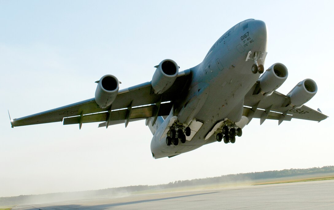 A C-17 Globemaster III takes off April 15, 2010, from Fort Pickett Maneuver Training Center, Va. The aircraft, carrying a group of Navy SEALs, was part of a joint training exercise with members of the 517th Airlift Squadron from Elmendorf Air Force Base, Alaska and SEAL Team 10. (U. S. Air Force photo/Staff Sgt. Brian Ferguson)