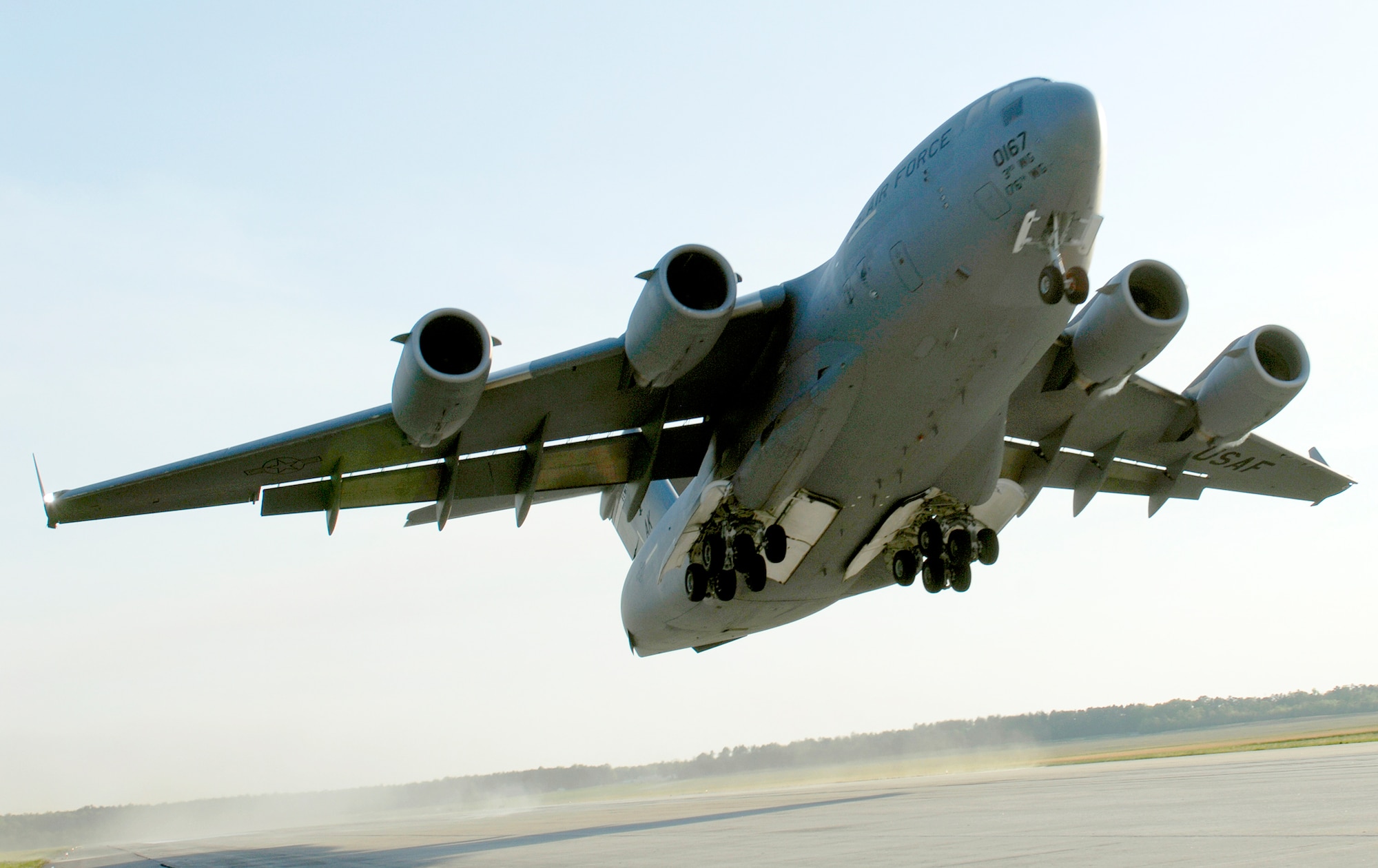 A C-17 Globemaster III takes off April 15, 2010, from Fort Pickett Maneuver Training Center, Va. The aircraft, carrying a group of Navy SEALs, was part of a joint training exercise with members of the 517th Airlift Squadron from Elmendorf Air Force Base, Alaska and SEAL Team 10. (U. S. Air Force photo/Staff Sgt. Brian Ferguson)