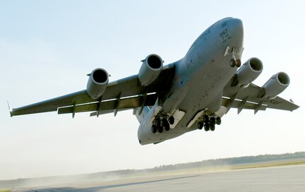 A C-17 Globemaster III takes off April 15, 2010, from Fort Pickett Maneuver Training Center, Va. The aircraft, carrying a group of Navy SEALs, was part of a joint training exercise with members of the 517th Airlift Squadron from Elmendorf Air Force Base, Alaska and SEAL Team 10. (U. S. Air Force photo/Staff Sgt. Brian Ferguson)