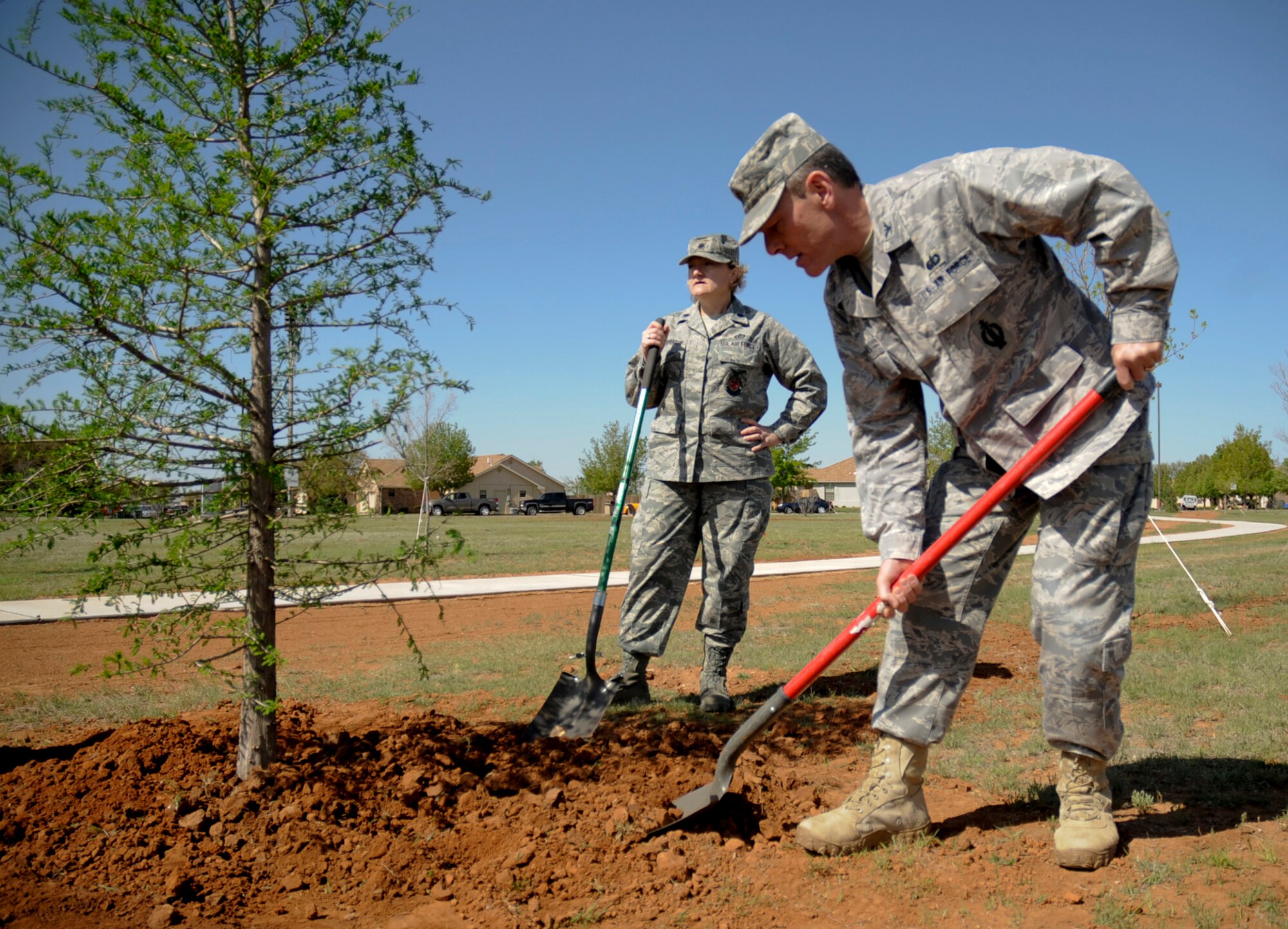 Col. Steven Kimball, 27th Special Operations Mission Support Group commander, and Lt. Col. Anne Coverston, 27th Special Operations Civil Engineer Squadron commander, plant a Bald Cypress tree at Cannon Air Force Base, N.M. April 22, Earth Day.  The Air Force joins millions across the nation and around the globe in observing Earth Day,to celebrate its daily commitment to the Earth Day theme  "Action Today for a Greener Tomorrow." In honor of Earth Day's 40th Anniversary, 39 former and active air force bases across America planted 40 trees in 40 communities as a symbol of the Air Forces commitment to environmental protection. (U.S. Air Force photo by Senior Airman Evelyn Chavez)