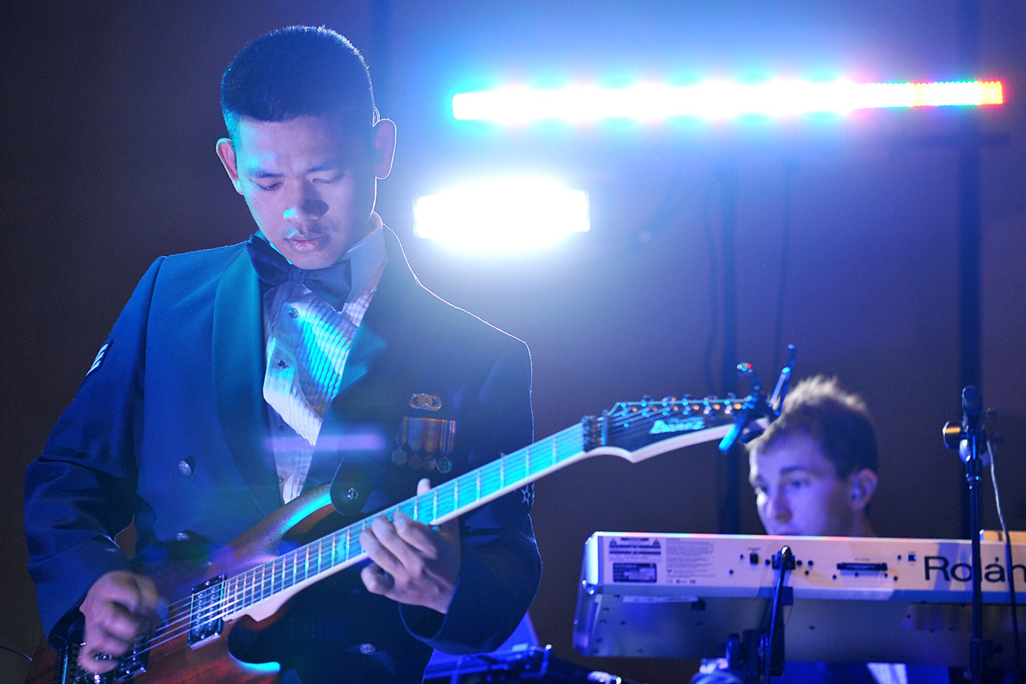 OFFUTT AIR FORCE BASE, Neb. -- Senior Airman Daniel Santos, a guitarist with the Heartland of America Band, plays the guitar during Air Combat Command's Outstanding Airmen of the Year banquet at the Embassy Suites hotel in La Vista, Neb., April 21. More than 200 people attended the ceremony to honor the command's best Airmen for their dedication, sacrifice and service. 
U.S. Air Force photo by Charles Haymond