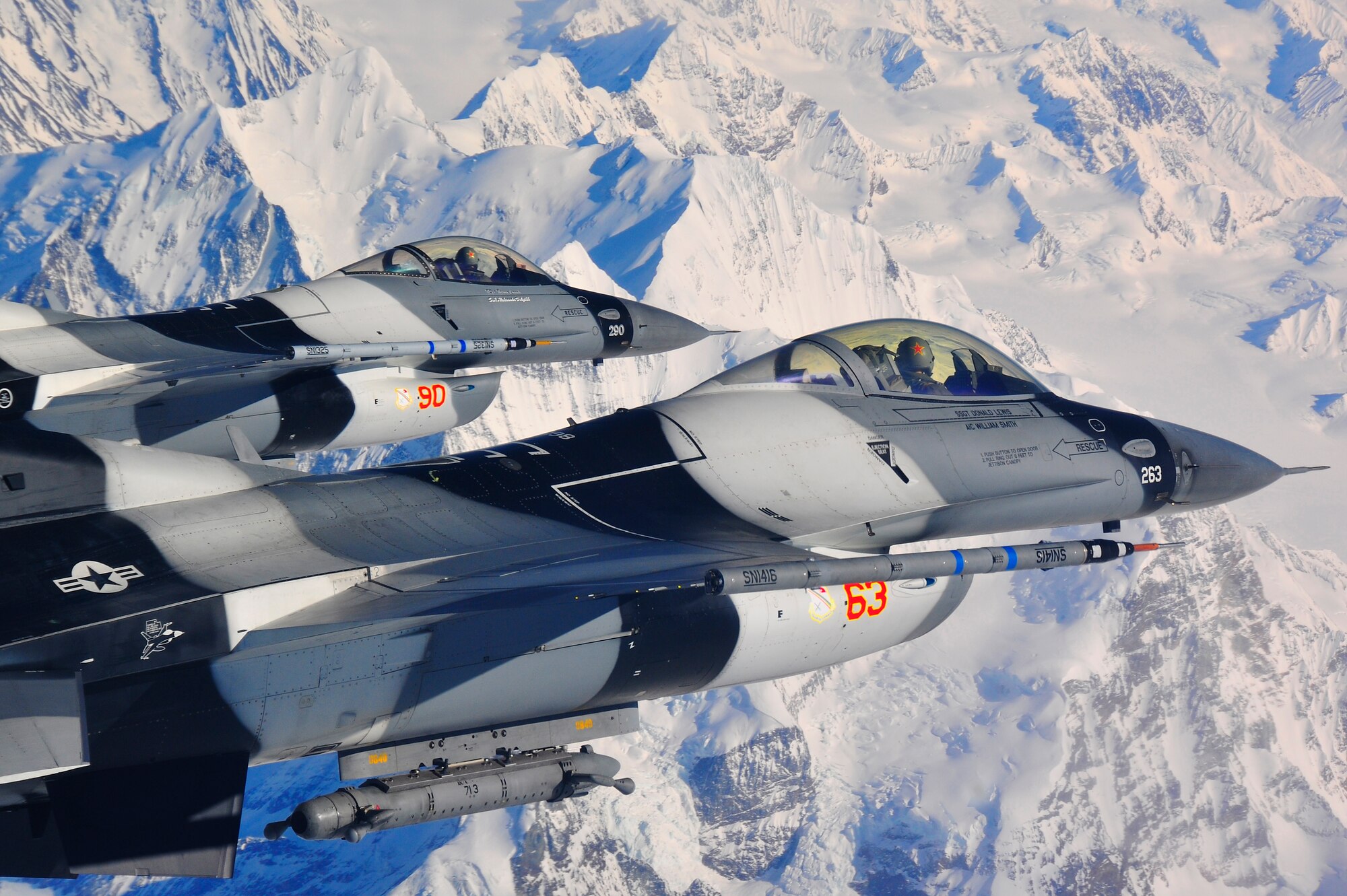 A pair of  F-16 Fighting Falcon Aggressors fly over the Alaska Range during RED FLAG-Alaska 10-2, April 20, 2010, Eielson Air Force Base, Alaska. RF-A provides participants 67,000 square miles of airspace, more than 30 threat simulators, one conventional bombing range and two tactical bombing ranges containing more than 400 different types of targets. The F-16s are assigned to the 18th Aggressor Squadron. (U.S. Air Force photo/Staff Sgt. Christopher Boitz)