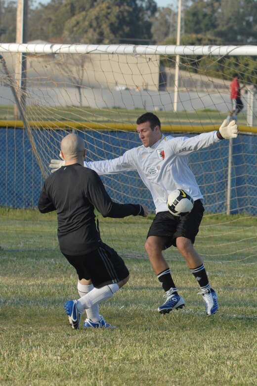 VANDENBERG AIR FORCE BASE, Calif. - Robert Lonak, a 30th Space Communications Squadron team member, blocks a shot from Diego Melgar-Grey, a 30th Medical Group team member, during an intramural soccer game here Monday, April 19, 2010. The 30th SCS team defeated the 30th Medical Group team 8 - 3. (U.S. Air Force photo/Senior Airman Christopher Hubenthal)

