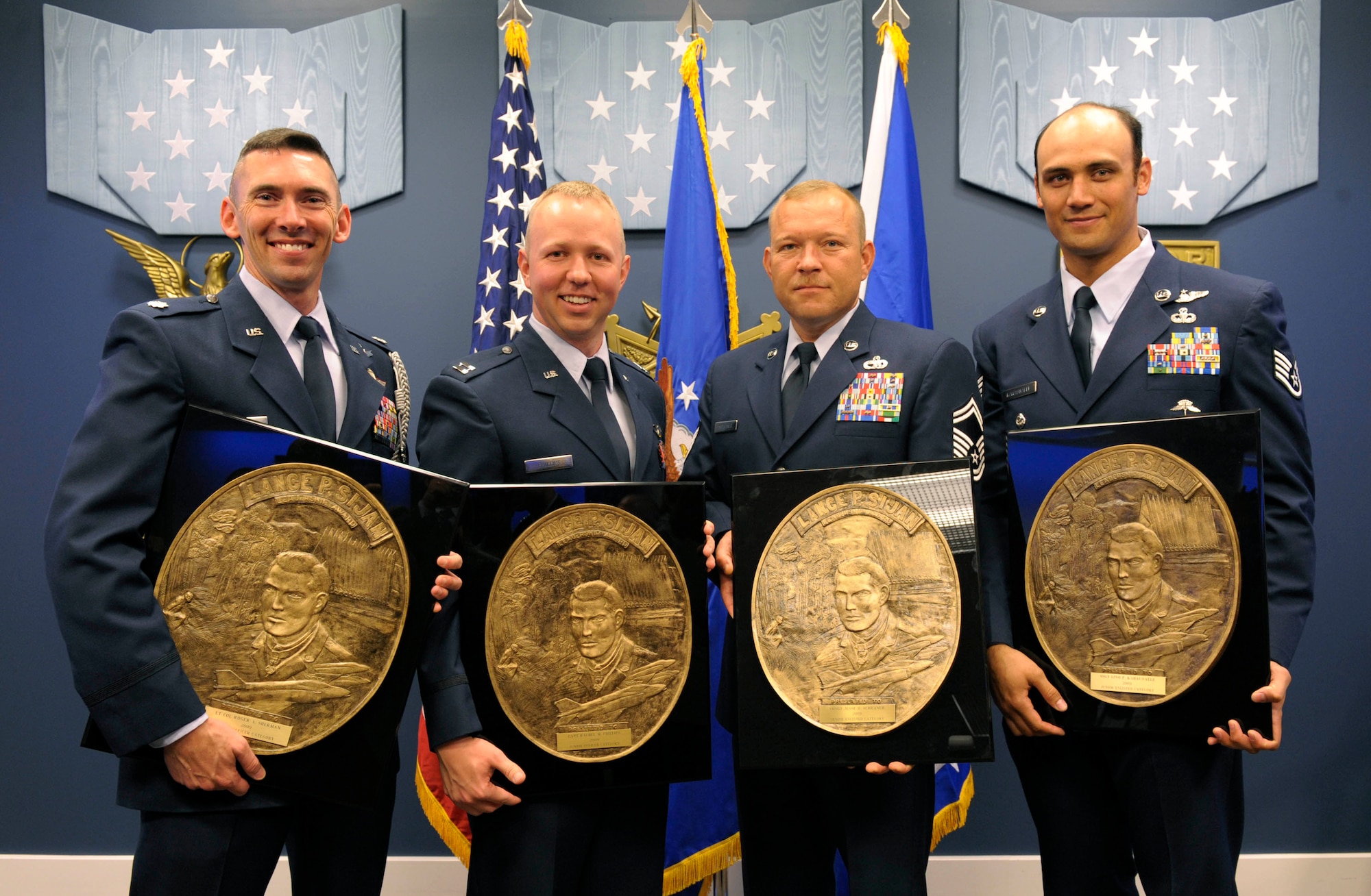 Lt. Col. Roger A. Sherman (from left), Capt. Thomas Phillips (accepting on behalf of his sister, Capt. Rachel Phillips), Senior Master Sgt. Jesse D. Schraner and Staff Sgt. Gino P. Kahaunaele pose with their respective 2009 Lance P. Sijan Leadership Awards following a ceremony April 21, 2010, in the Pentagon's Hall of Heroes.  The annual award was created in 1981 to recognize four Airmen who demonstrate the highest qualities of leadership both in and out of uniform. (U.S. Air Force photo/Jim Varhegyi)