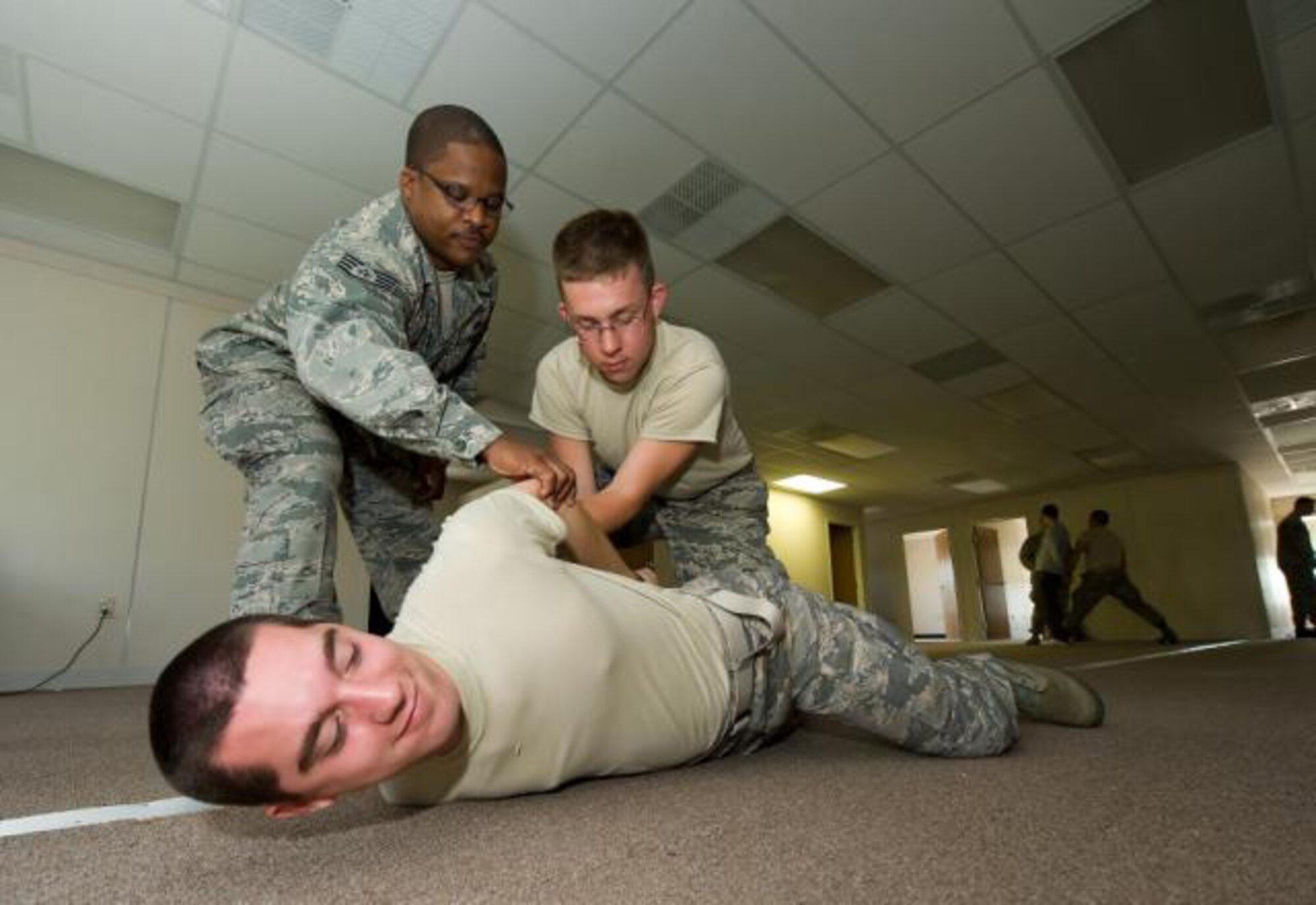 Staff Sgt. Quinton Allen, 512th Security Forces Squadron fire team leader, teaches University of Delaware Reserve Officer Training Course detachment 128 cadets Gavin Nugent (middle) and Jon Saddler (bottom) how to property conduct a search of a suspect here April 16. Members of the 512th SFS participated in a University of Delaware ROTC field training excercise. The three-day training event was created by University of Delaware ROTC leadership to expose future military officers to Air Force operational career fields and scenarios. (U.S. Air Force photo/Jason Minto) 