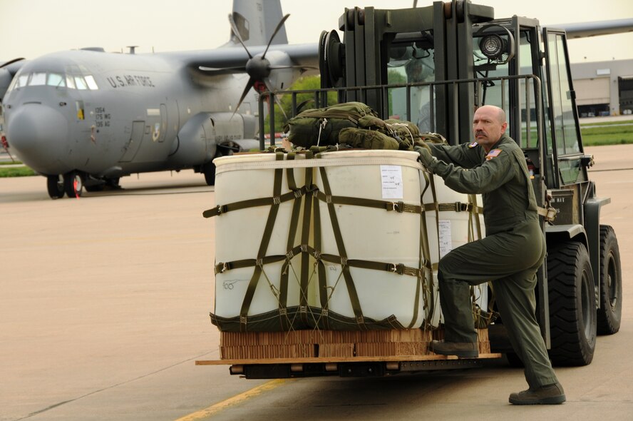 Master Sgt. Don Farruggia, a loadmaster with the Maryland Air National Guard's 135th Airlift Squadron, inspects a container delivery system bundle prior to loading it onto a C-130J at Warfield Air National Guard Base in Baltimore, Md., on April 20, 2010. The CDS bundle will be airdropped out the back of the airplane for a precision delivery during a training flight. (U.S. Air Force photo by Tech. Sgt. David Speicher/Released)