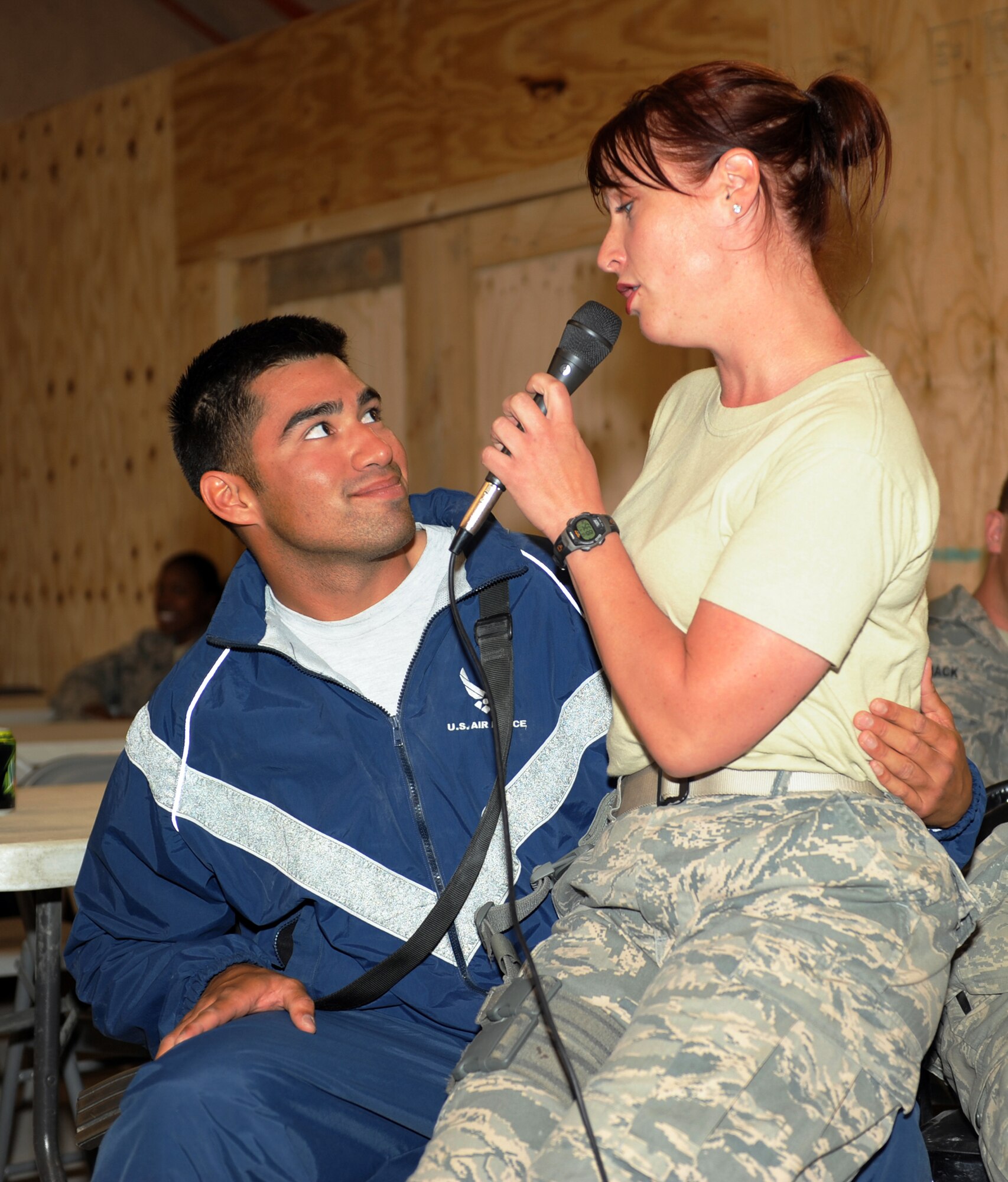 Airman 1st Class Jill Diem serenades Senior Airman Luis Murillo during a concert April 17, 2010, at Bagram Airfield, Afghanistan. Airman Diem is a vocalist with the U.S. Air Forces Central Band Reserve Generation and Airman Murillo is assigned to the 455th Expeditionary Civil Engineers Squadron Force Protection Flight. (U.S. Air Force photo by/ Staff Sgt. Richard Williams)