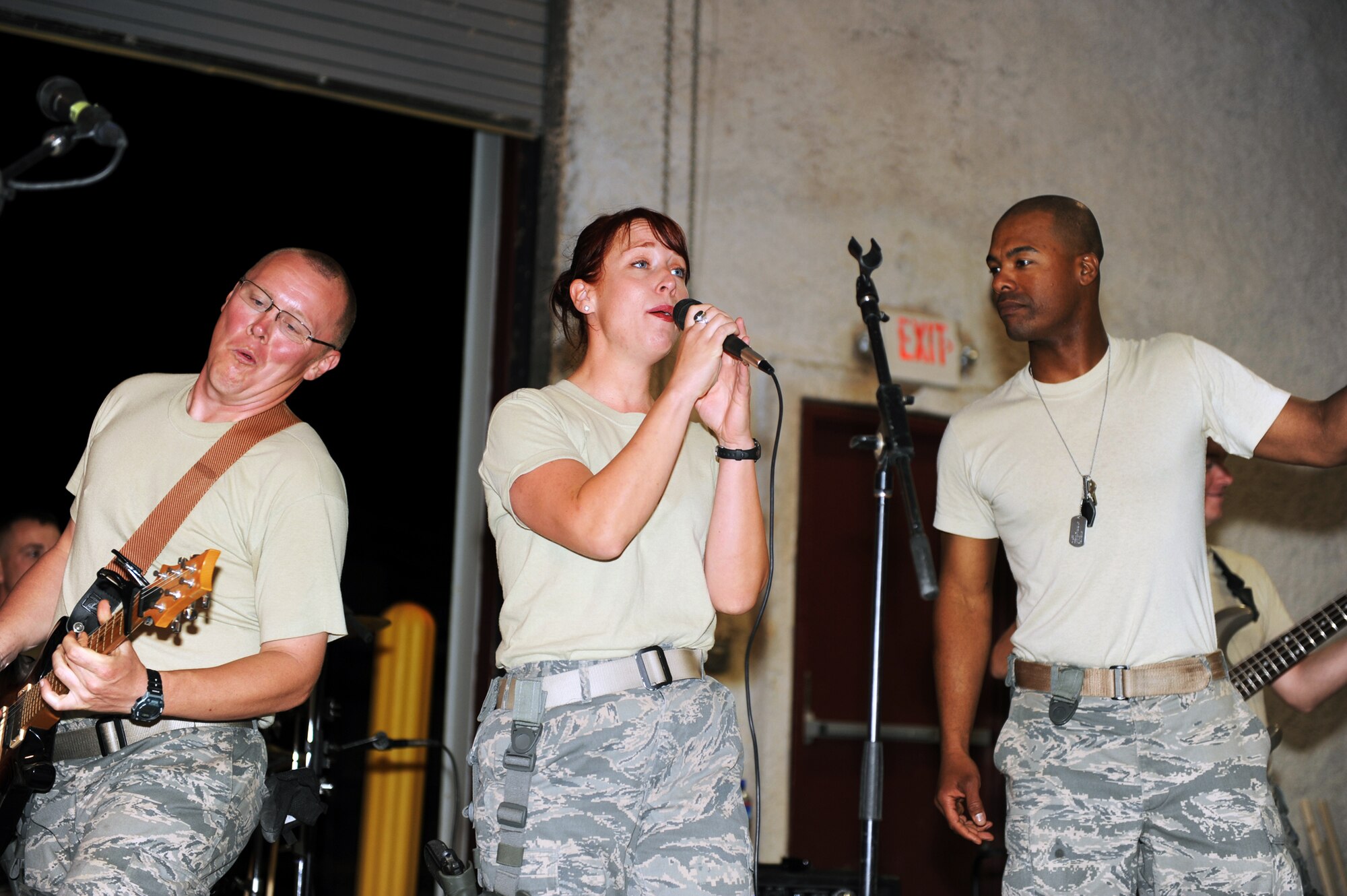 Senior Airman Josh Byrd (left) Airman 1st Class Jill Diem and Master Sgt. Aaron Miles perform April 17, 2010, at Bagram Airfield, Afghanistan. Airman Byrd is a guitarist, Airman Diem is a vocalist and Sergeant Miles is the NCO in charge of the U.S. Air Forces Central Band Reserve Generation. (U.S. Air Force photo by/ Staff Sgt. Richard Williams)