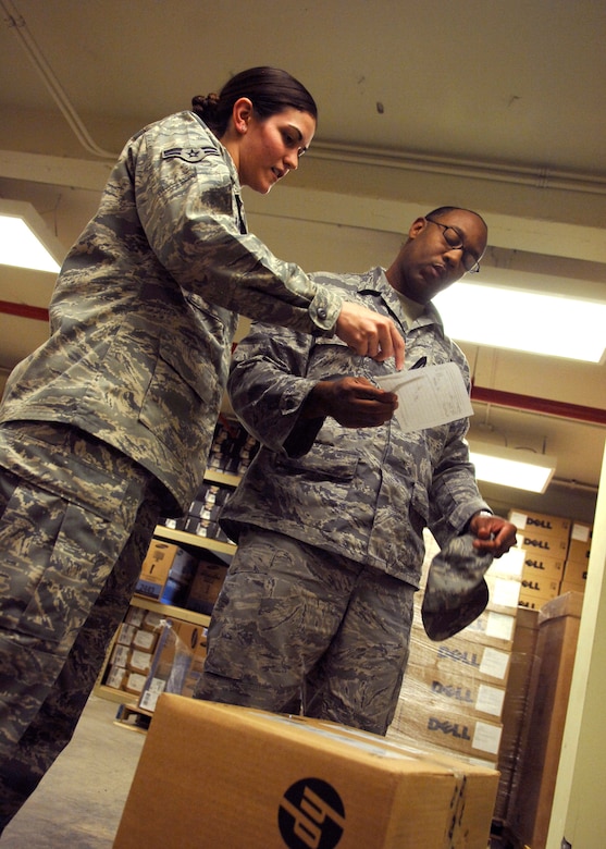 Airman 1st Class Cassandra LaVoie shows a customer the information required on a Form 1297 to issue equipment out at the Automatic Data Processing Equipment warehouse April 20, 2010, on Joint Base Charleston, S.C. A Form 1297 is a hand receipt used to track the equipment issued to each office in the ADPE Asset Inventory Management system. Airman LaVoie is an Information Technology Asset Manager for the 628th Communications Squadron. (U.S. Air Force photo/Senior Airman Timothy Taylor)