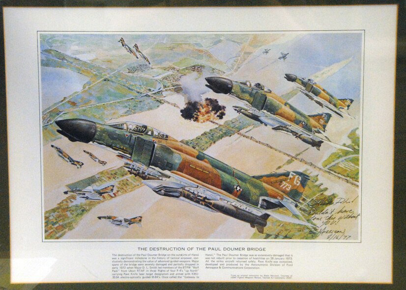 This lithograph by a fighter pilot commemorates a misssion where Smith successfully bombed the mile-long Paul Doumer Bridge. The Buhlers have one copy, while another hangs in the Air Force Weapons School.
