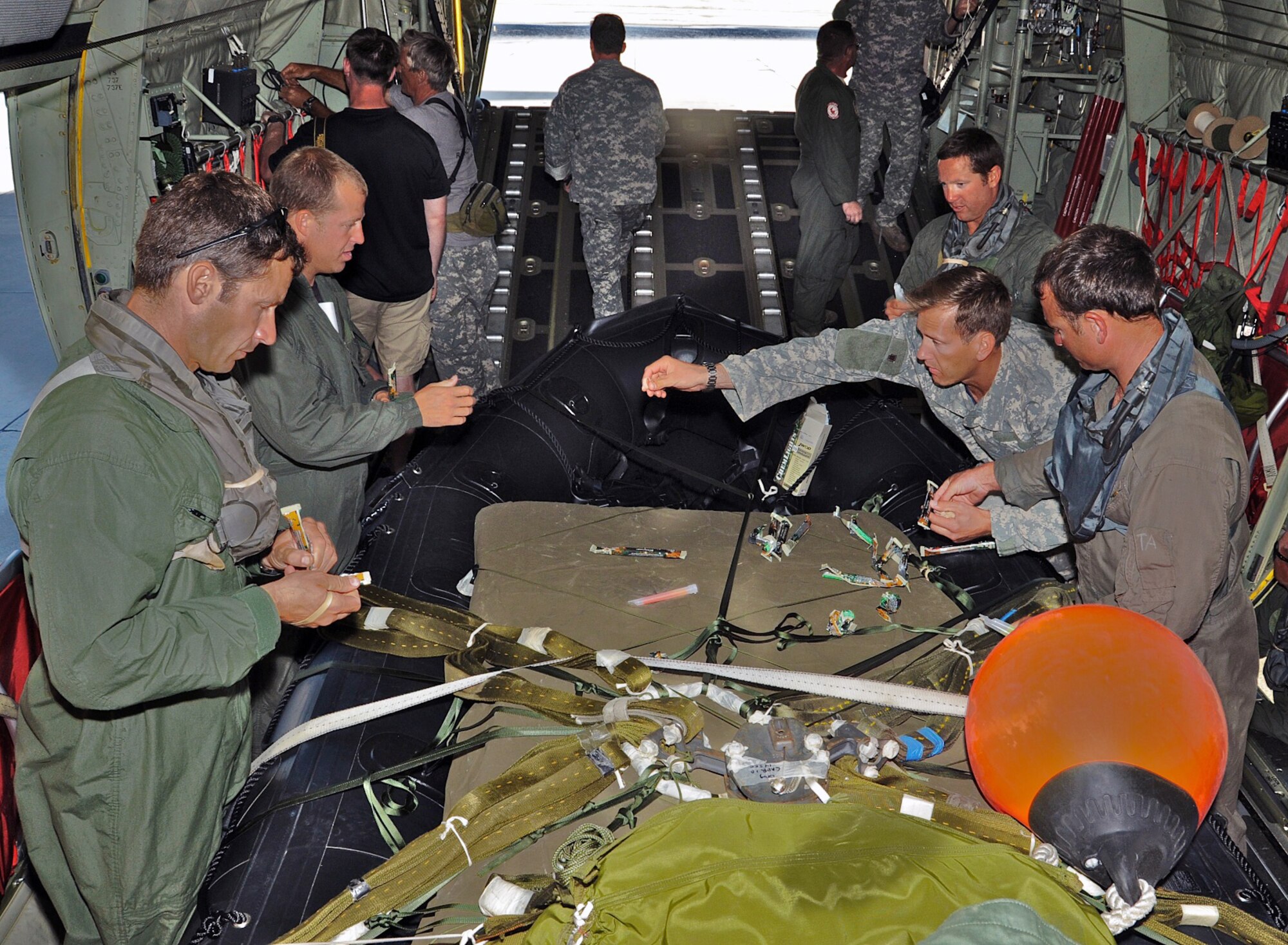 Army instructors assist 815th Airlift Squadron loadmasters in preparing the assault raft for the aircraft's takeoff April 12, 2010, in Key West, Fla. (U.S. Air Force photo/Tech. Sgt. Tanya King)
